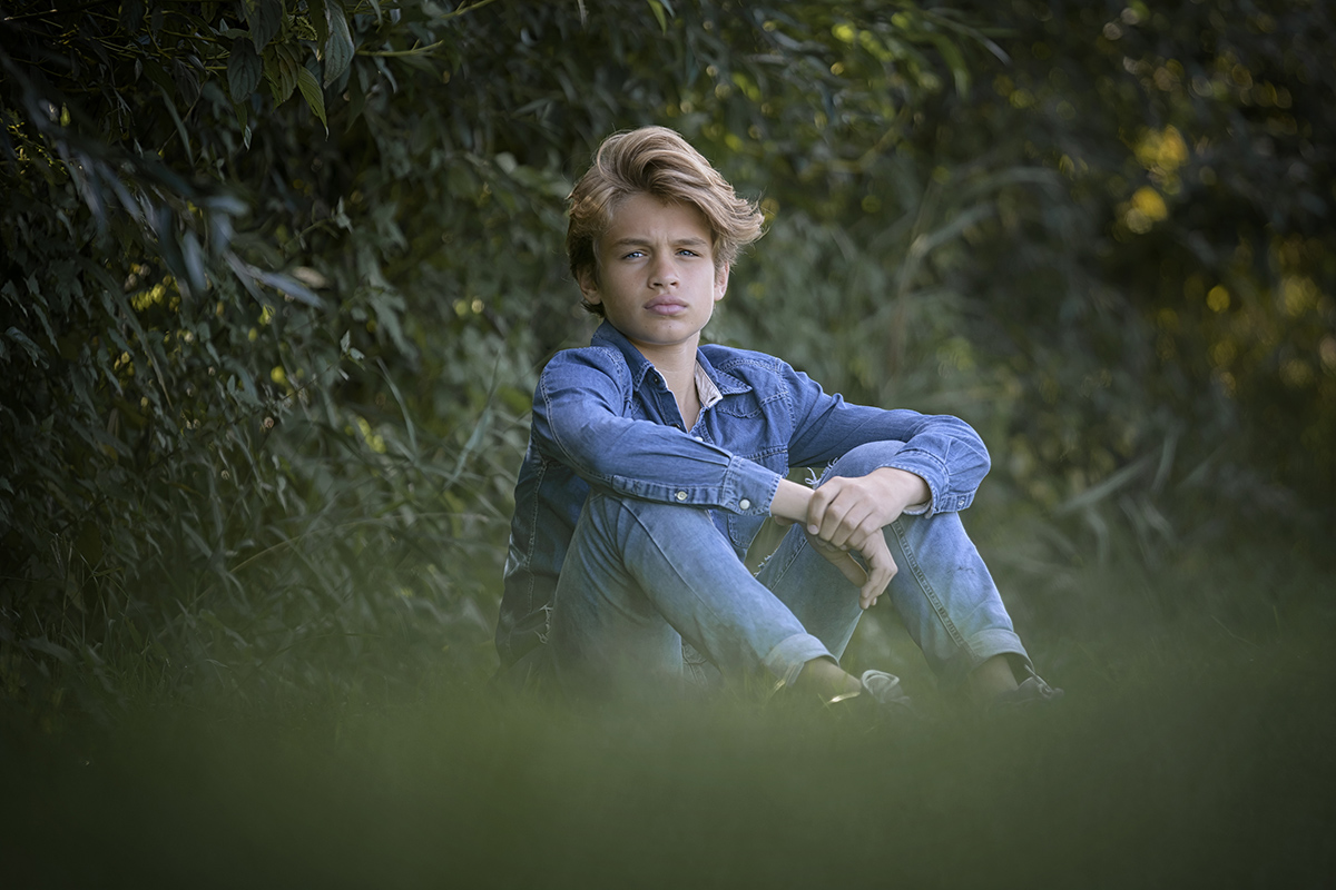 portret van jongen zittend buiten voor zijn modelportfolio.jpg