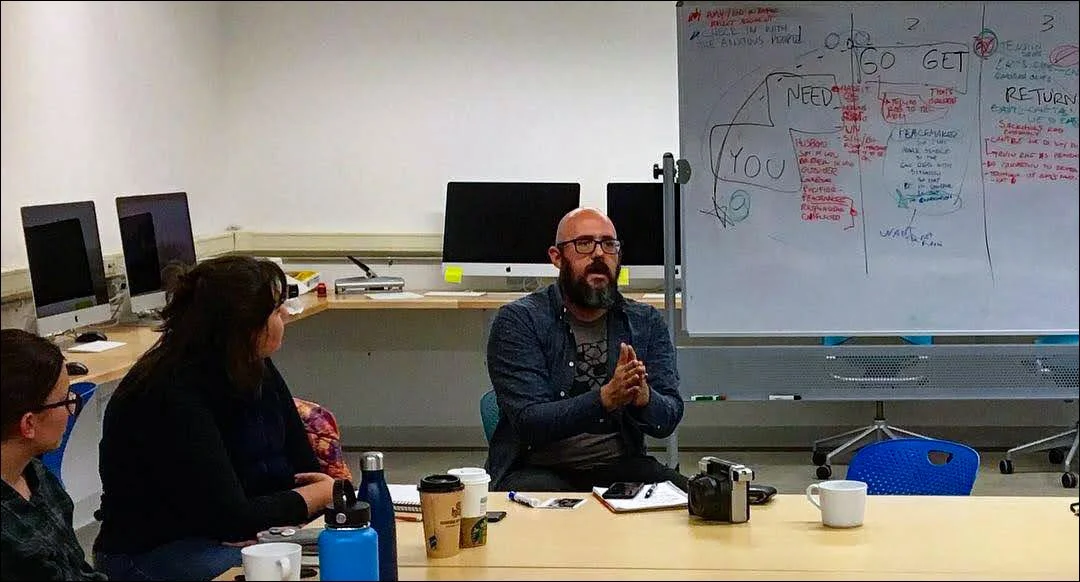 Jeff Simmermon gives feedback to a participant during an in-person storytelling session.