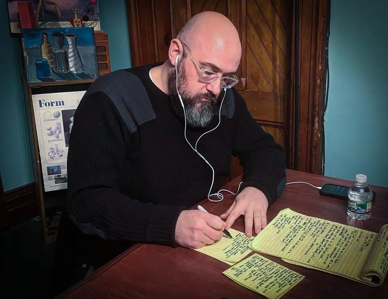 Jeff Simmermon writing and revising handwritten story notes.