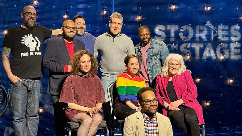 Jeff Simmermon with host Wes Hazard and seven storytellers on the PBS Stories From the Stage set at the March 19, 2026 taping.