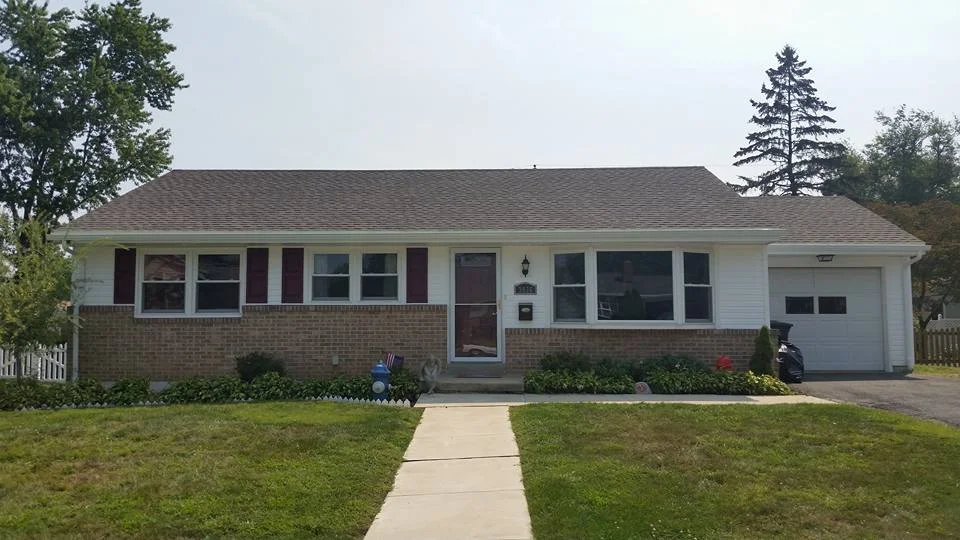 At this home we installed all new vinyl siding, architectural shingles, vinyl shutters, and seam less gutters. 