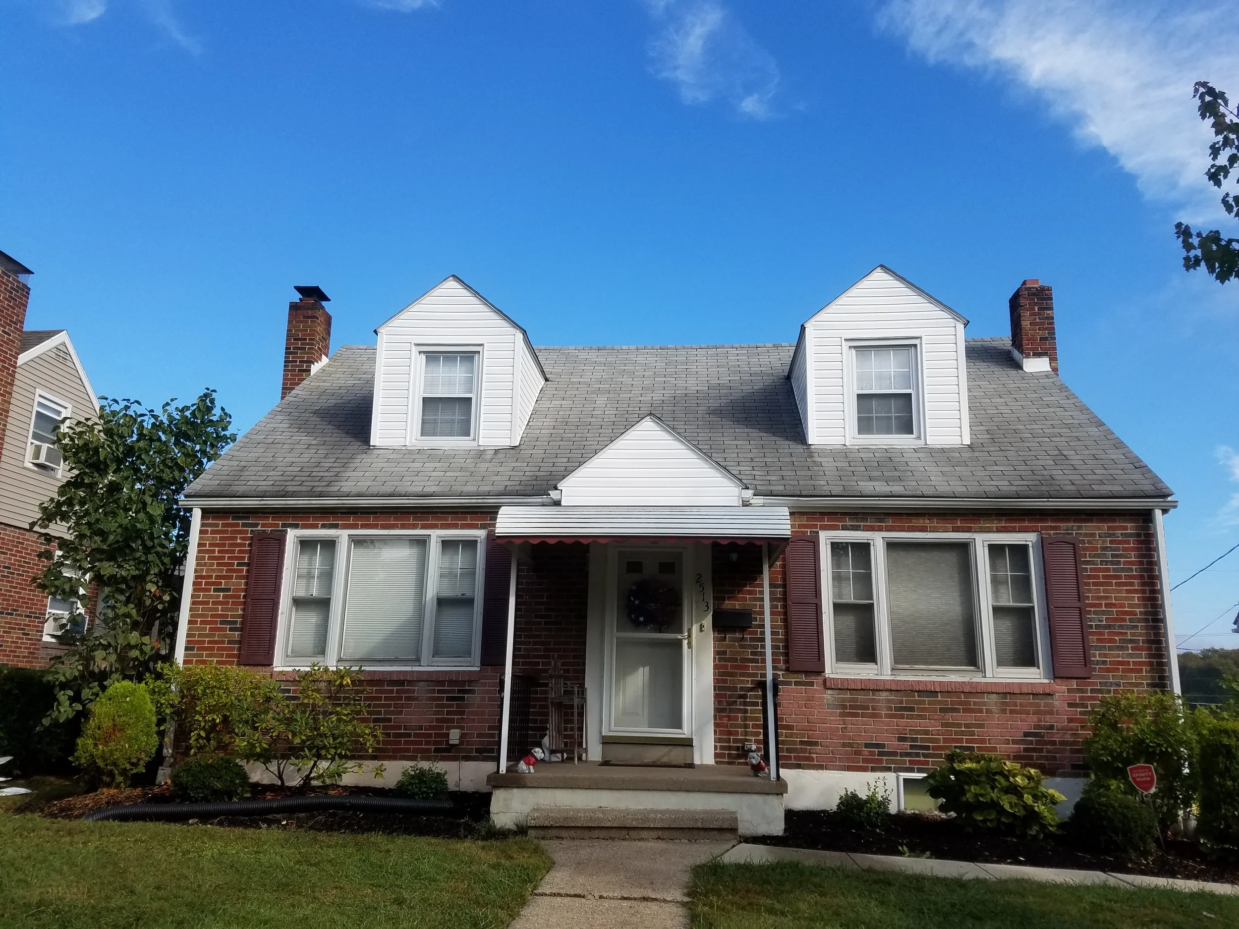 Vinyl siding installed on dormers and gable end of this Cape Cod to replace old worn out aluminum siding.