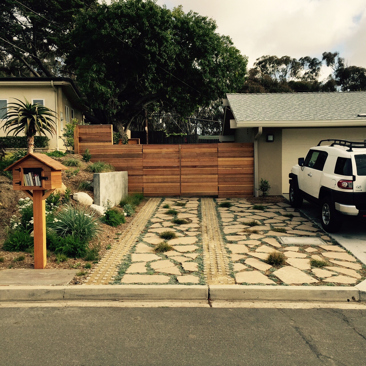 Pervious paving combination: Urbanite (broken pieces of old concrete) and Grass-pave filled with DG, Dymondia and Carex grasses.