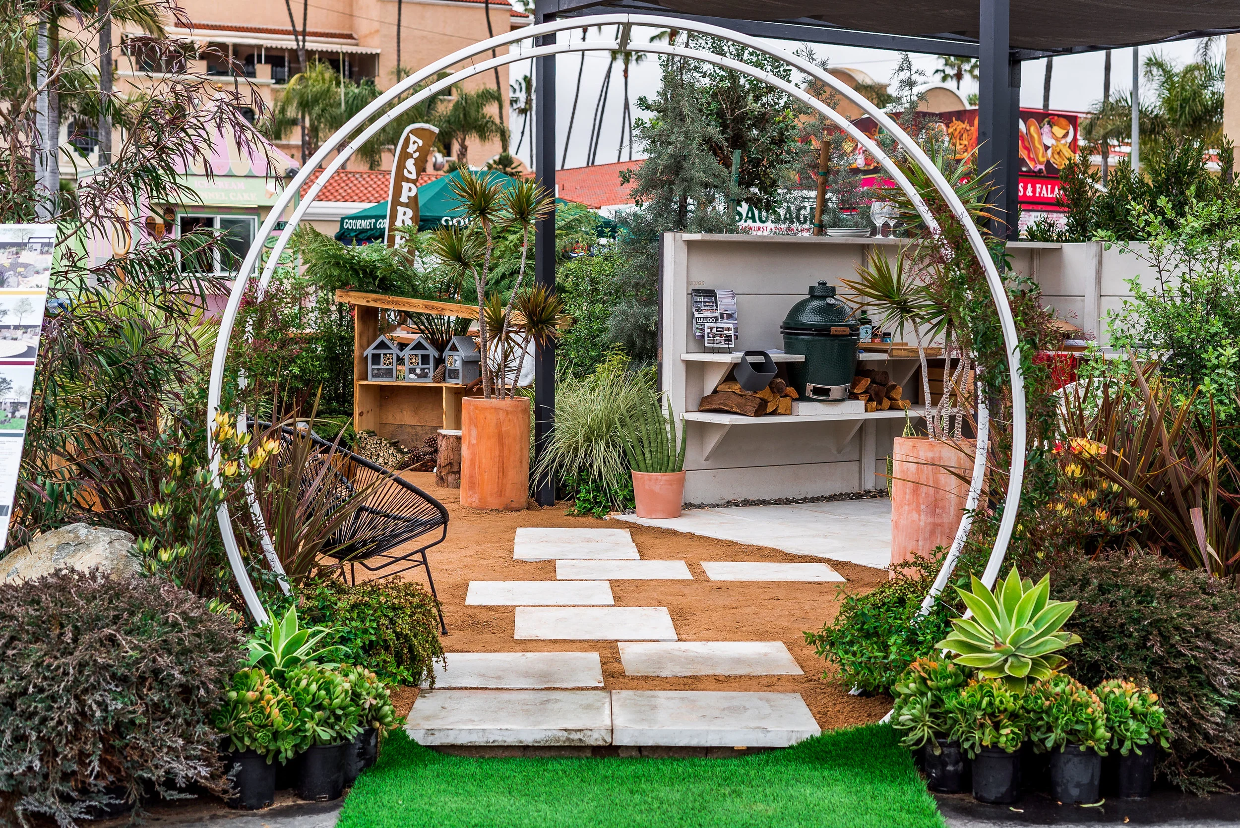 Terra Sculpture’s , “Modern Arbor Trellis,” is the main entryway into the design. We intentionally left the plants in their containers in order to avoid raising the whole garden. We did this so there is a more fluid entry in and out of the garden.