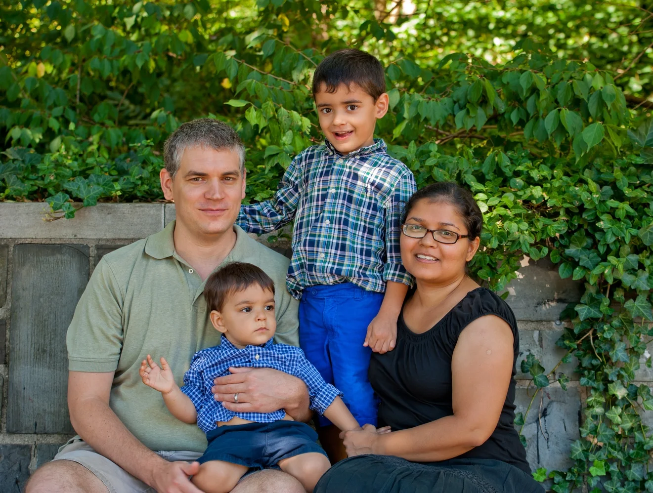 Mother, Son and her two sons sitting on bench in Central Park for their family session in Central Park, New York