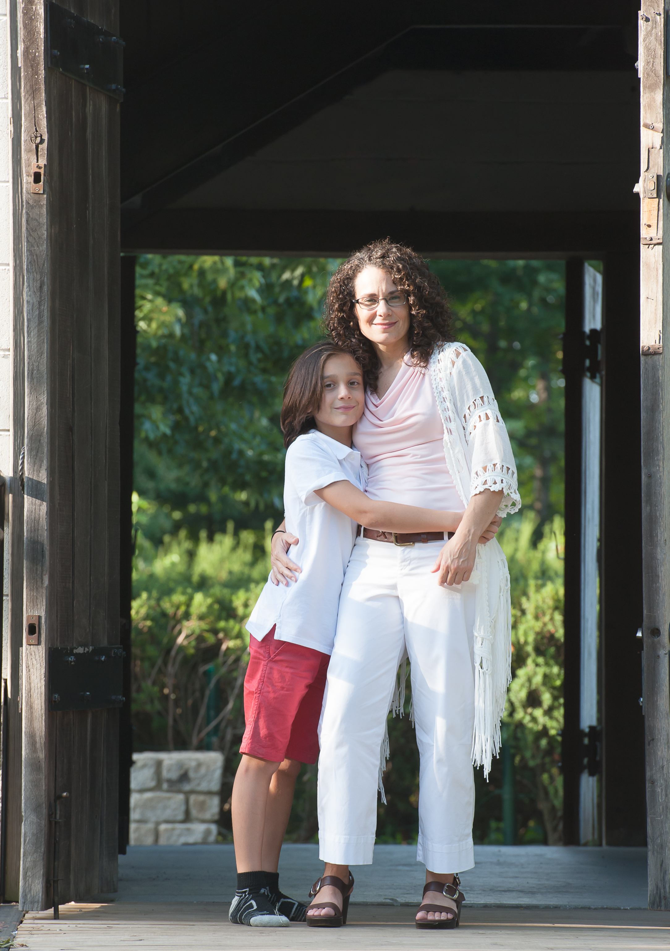 Mother and tween son hugging at Snug Harbor, Staten Island, NY