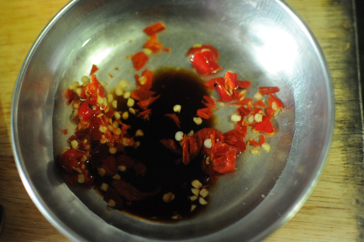 Prepare the Thai Birds eye chili in vinegar and soya sauce. Handle carefully this will burn your fingers and your mouth