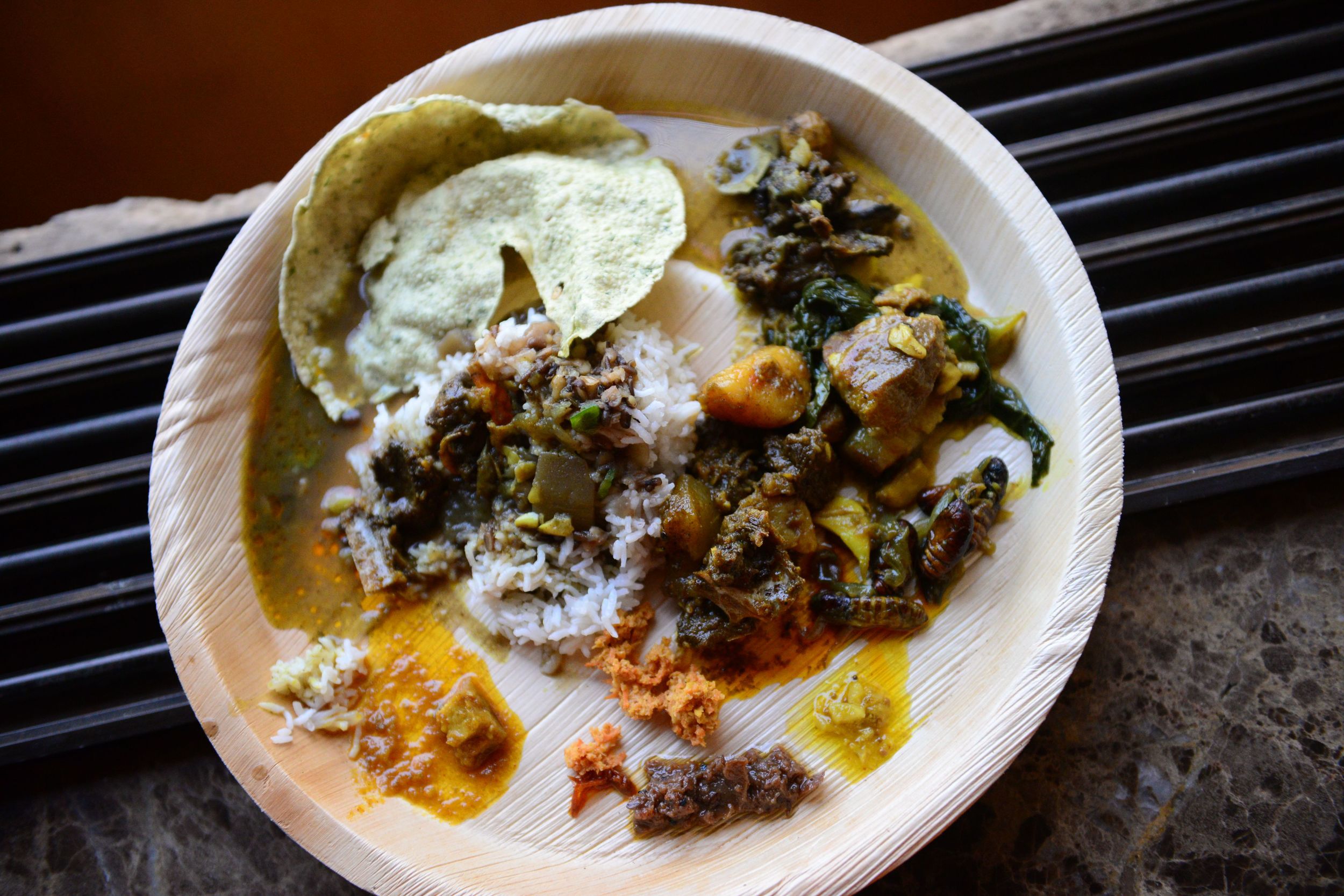 My plate of all the yummy curries, silkworms, pickles, sticky rice and dal