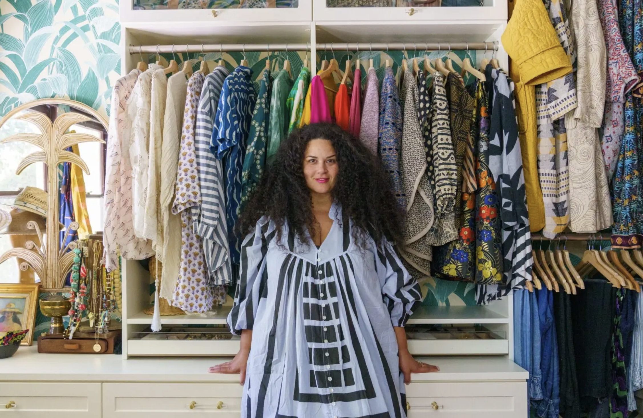 Justina Blakeney standing in a moomoo in her closet 