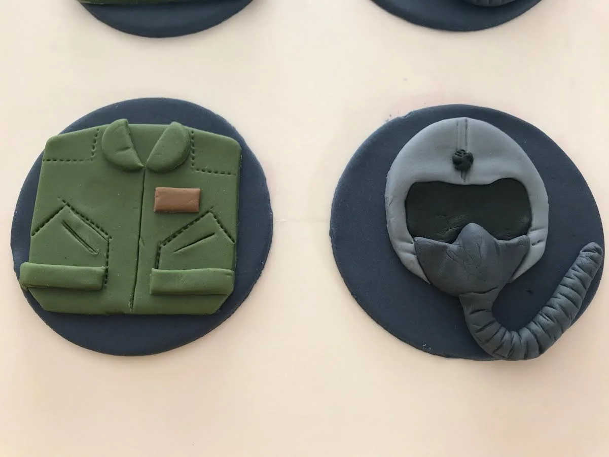 Flight suit and flight helmet cupcake toppers