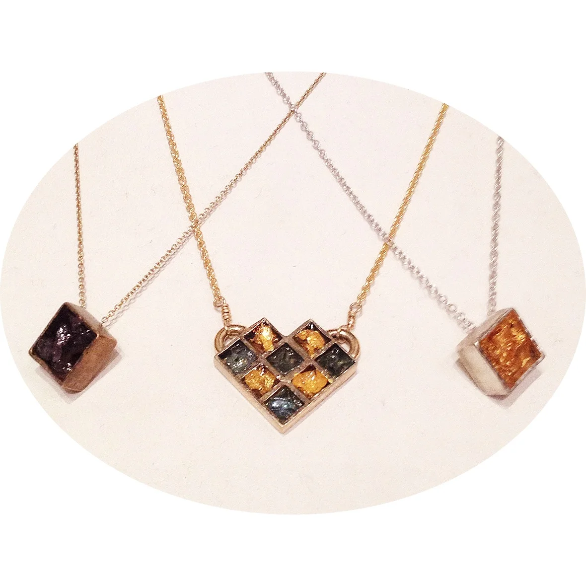 Signature resin pieces spawned the new Honeycomb Series (center). From left: bronze with crushed amethyst, bronze honeycomb with 24-karat gold leaf & crushed green glass, sterling silver with 24-karat gold leaf.