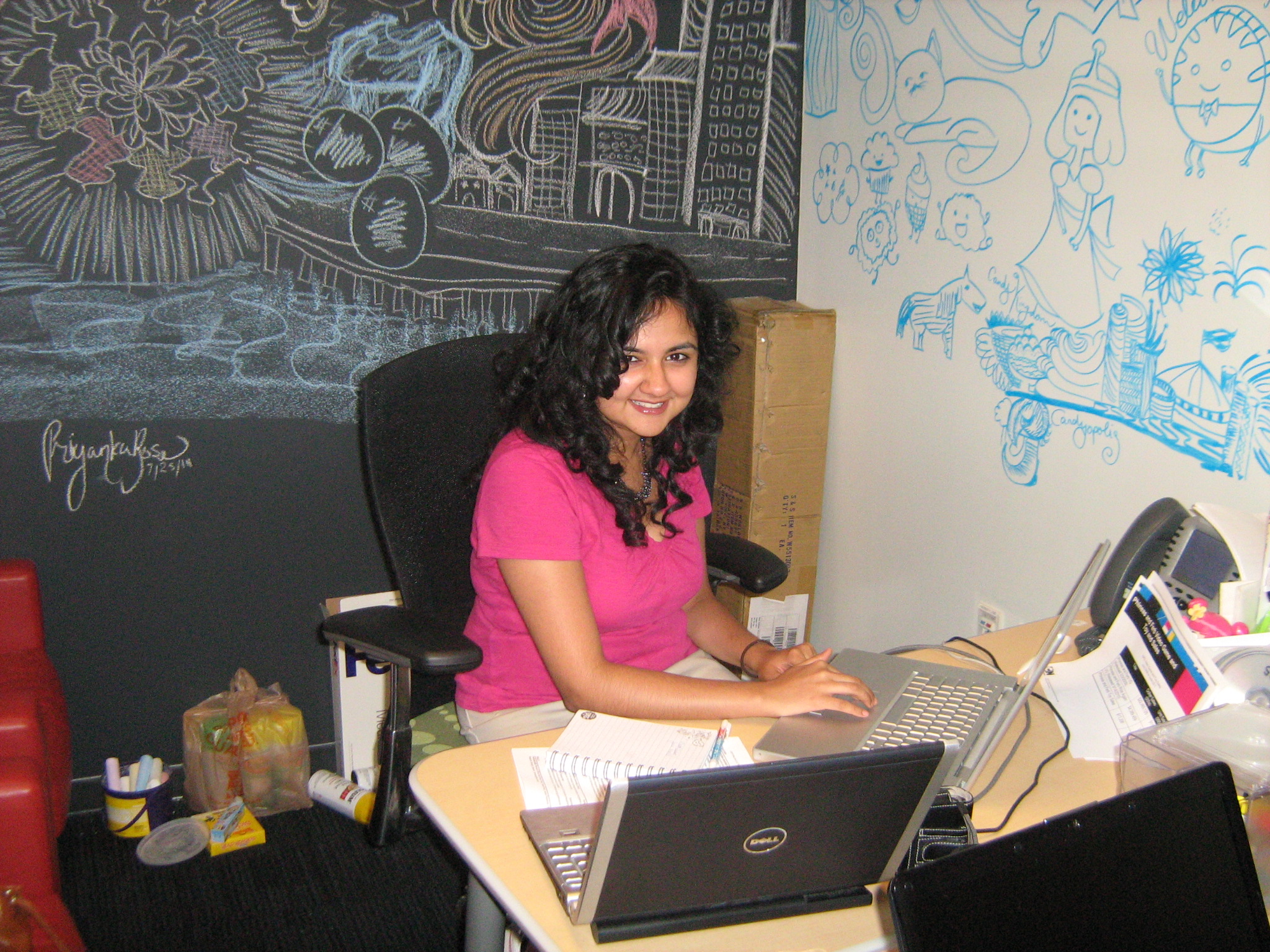 Me hard at work in my intern office at Cartoon Network! Behind me is a whiteboard wall and a chalkboard wall. All doodles are mine.