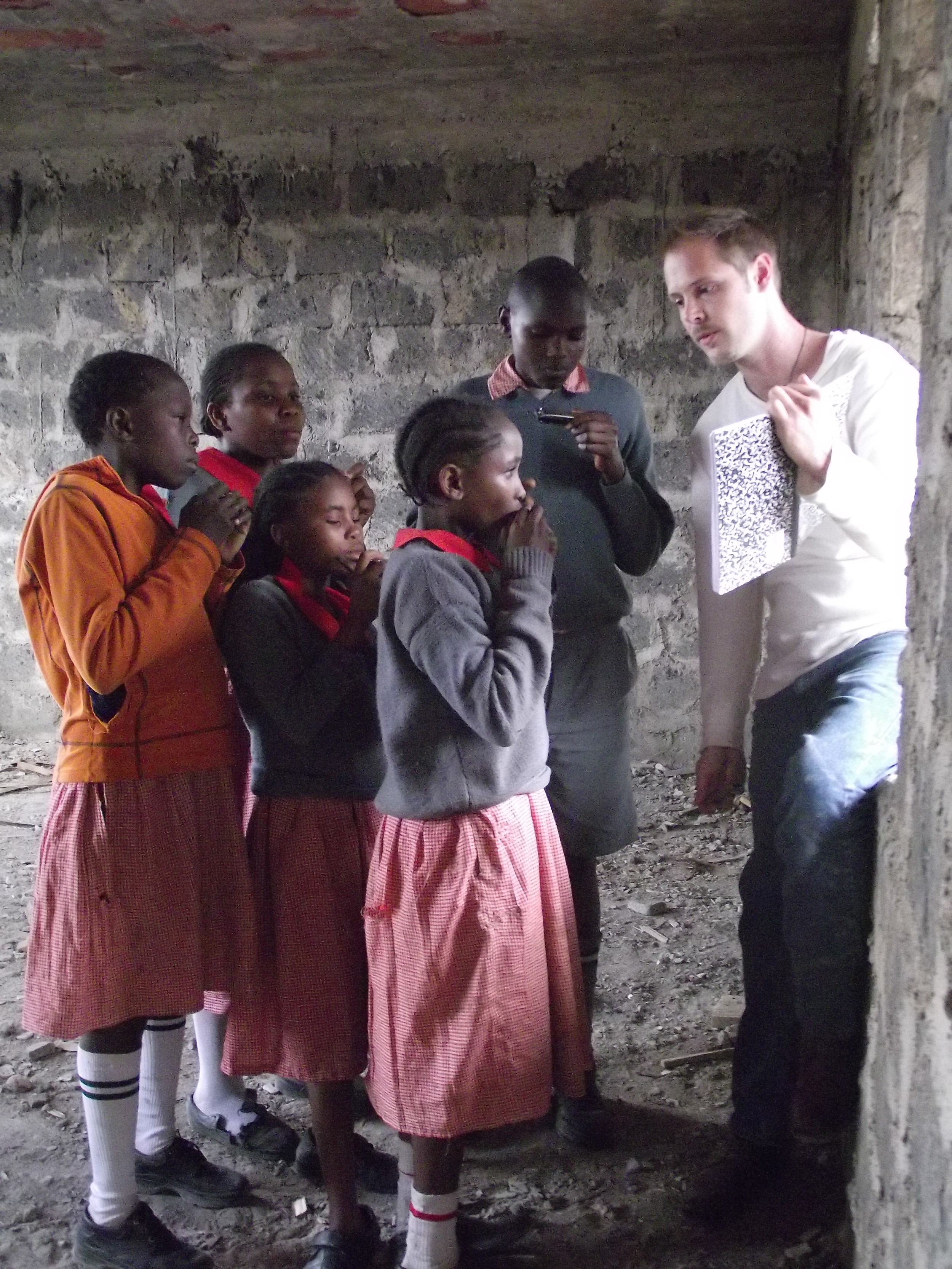 Music - Billy teaching harmonica Mathare.JPG