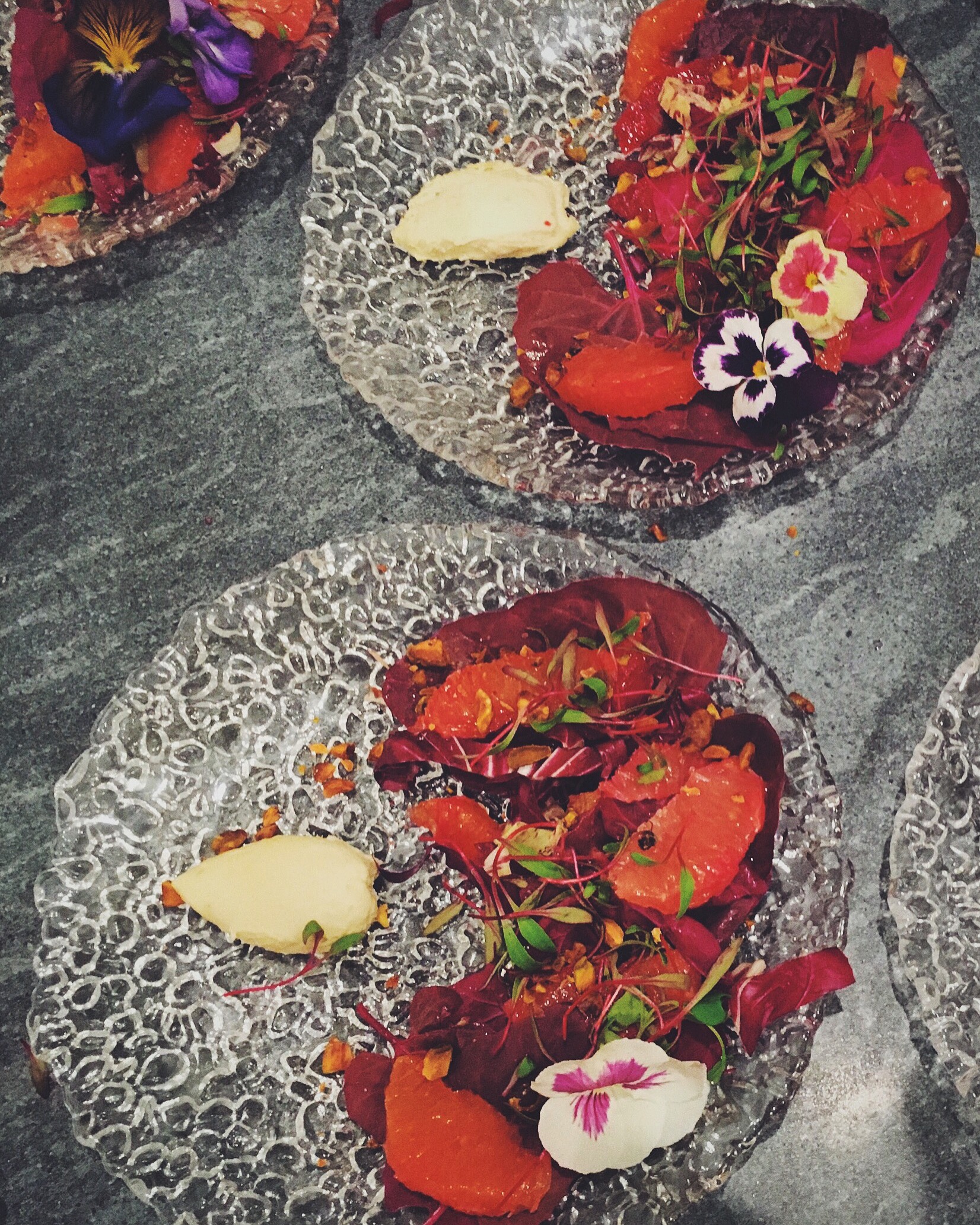 Winter sunset salad. Orach, mixed citrus, beet sprouts, pistachio, jasmine creme, and a hibiscus vinaigrette. 