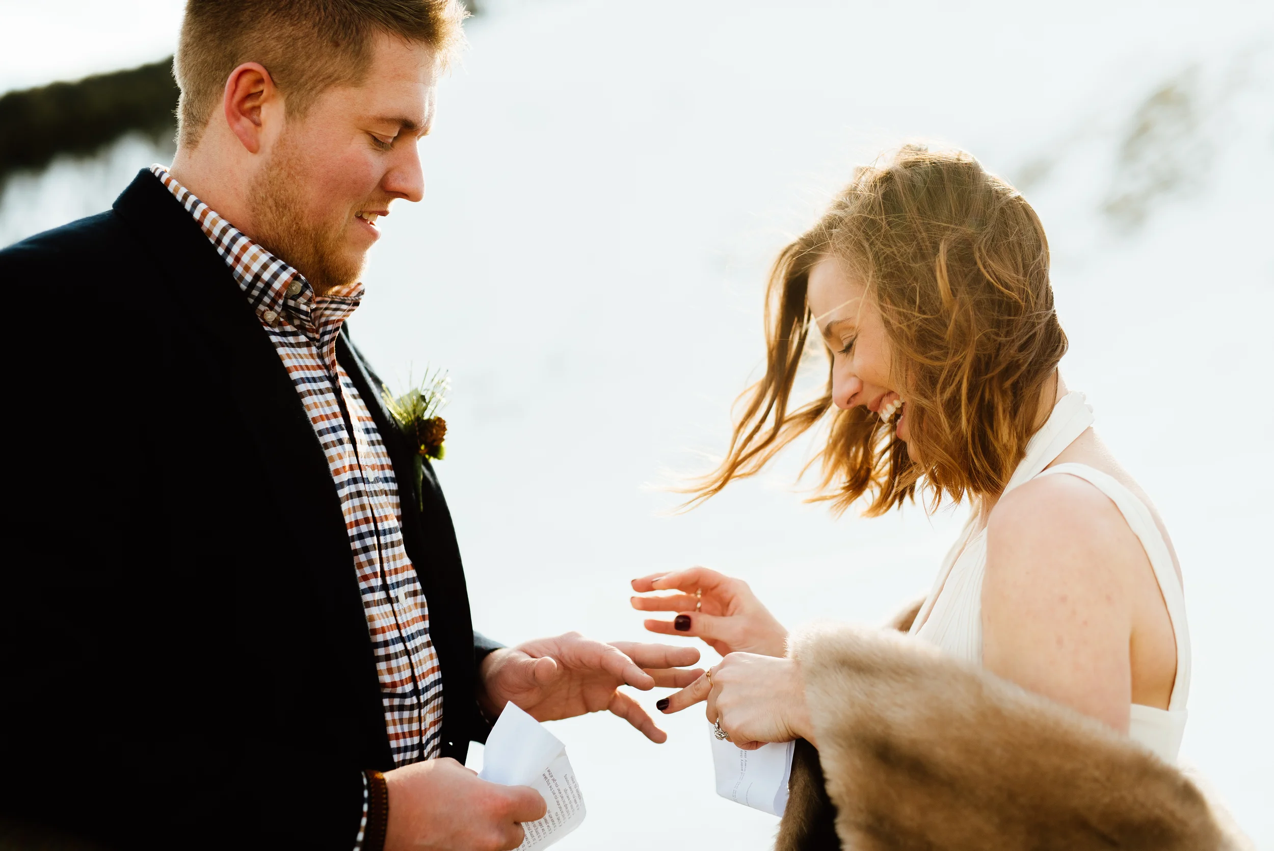 What a fun little snowy wedding ceremony up in the Rocky Mountains! I love Kelsie's fur shawl she is wearing over that gorgeous ivory wedding dress. | Intimate wedding photos by outdoor mountain elopement photographer, Maddie Mae.