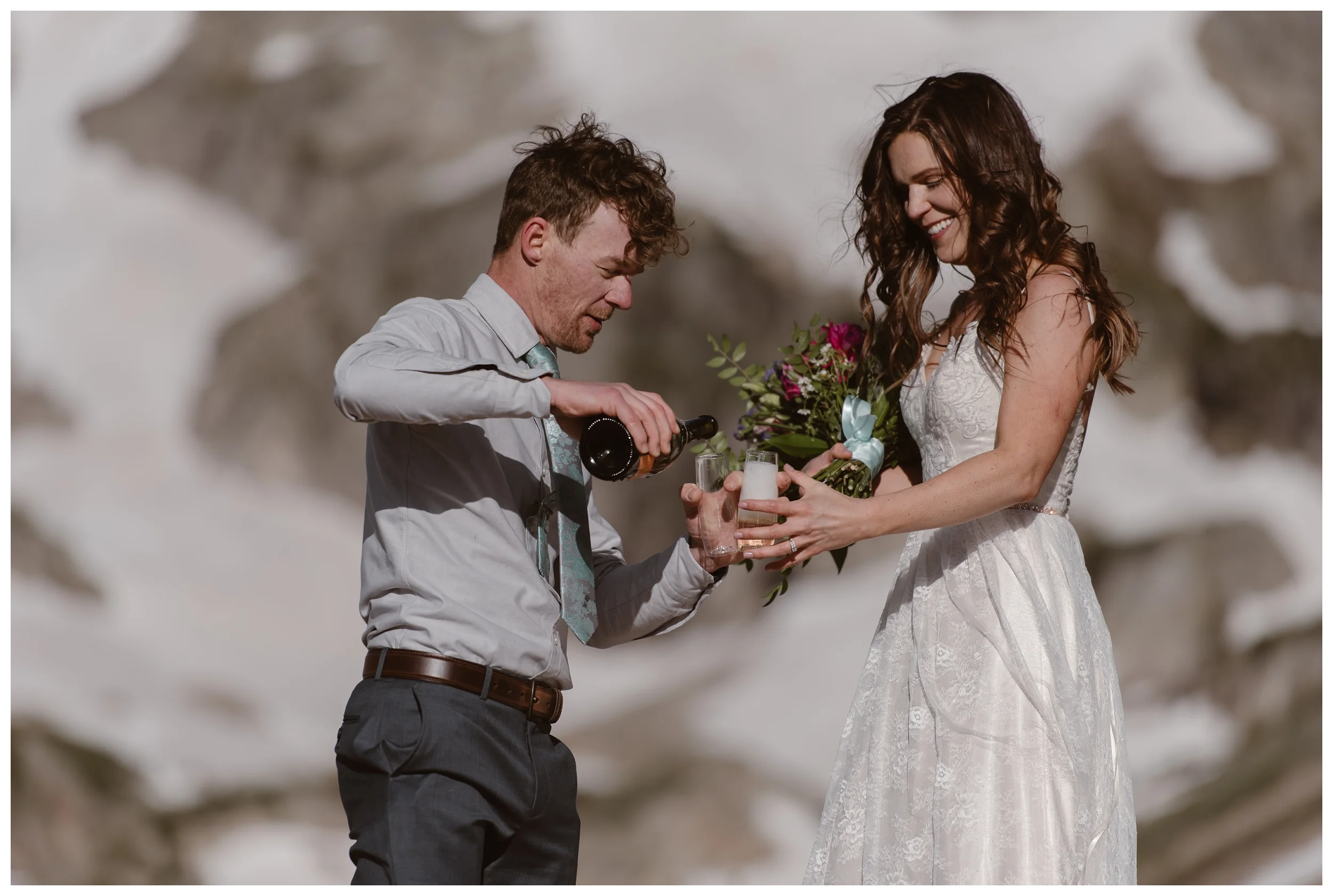 Matt and Karen share a glass of champagne to celebrate after their self solemnizing hiking elopement ceremony in Nederland, Colorado. Photo by Adventure Instead, Maddie Mae.
