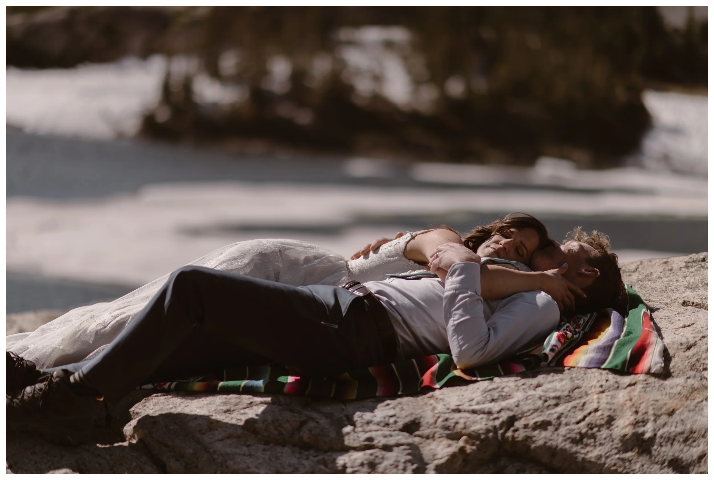 Karen and Matt embrace following their high alpine lake elopement ceremony at Lake Isabelle, outside Nederland and Boulder, Colorado. Photo by Adventure Instead, Maddie Mae.