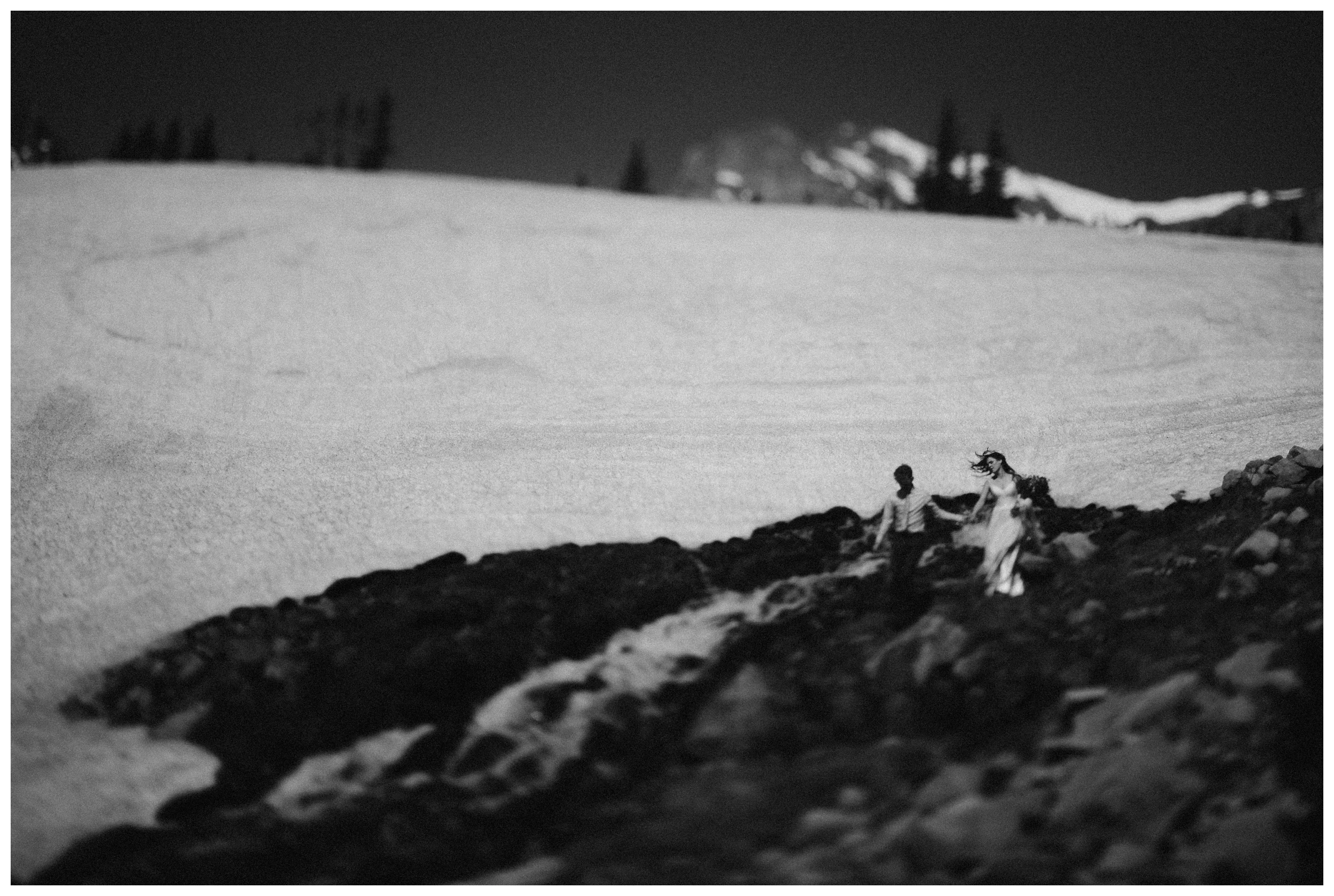 Karen and Matt explore the snowy shores of Lake Isabelle outside Nederland, Colorado following their high alpine lake hiking elopement ceremony. Photo by Adventure Instead, Maddie Mae.