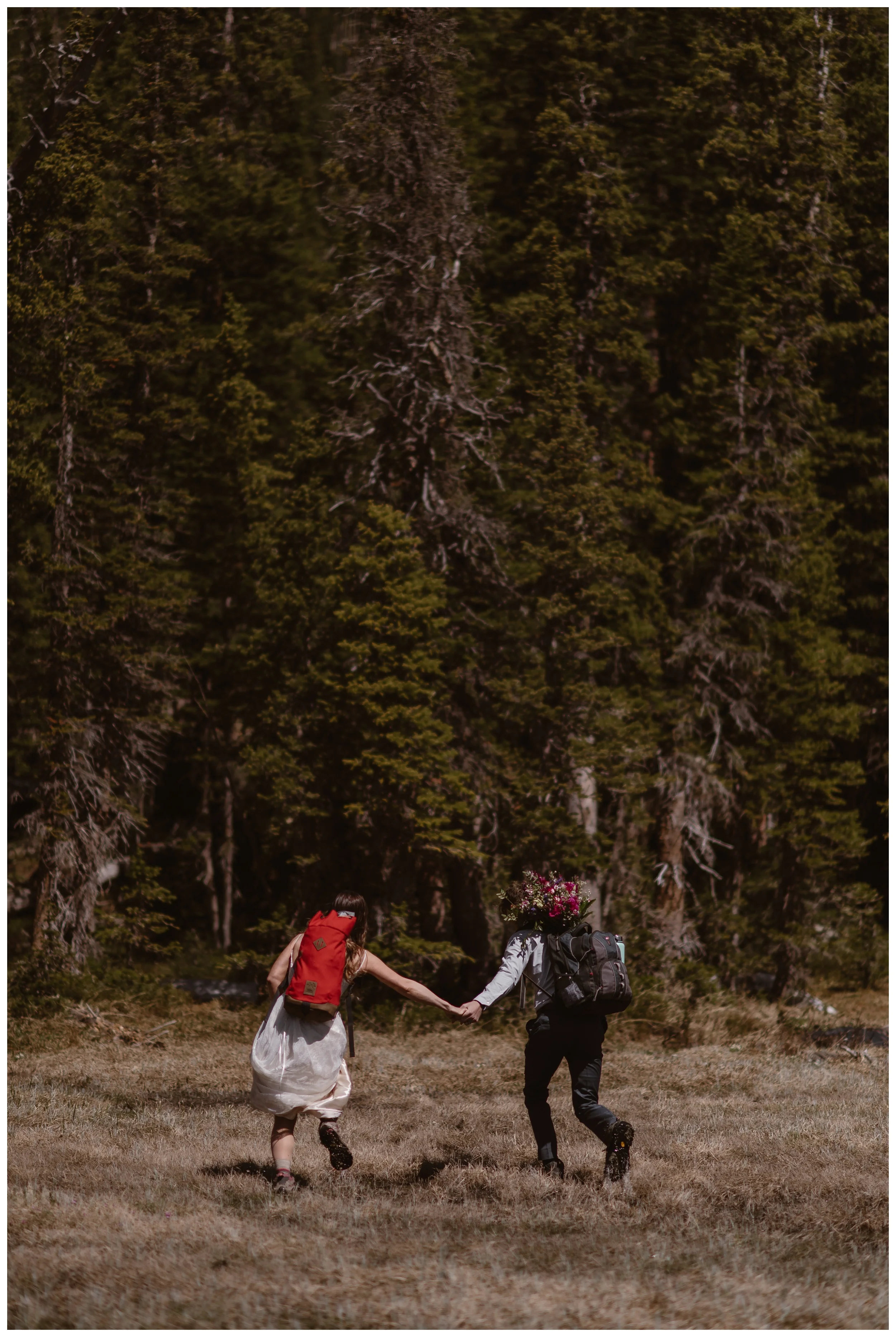 Karen and Matt begin the hike down following their high alpine adventure lake elopement ceremony in Nederland, Colorado. Photo by Adventure Instead, Maddie Mae.