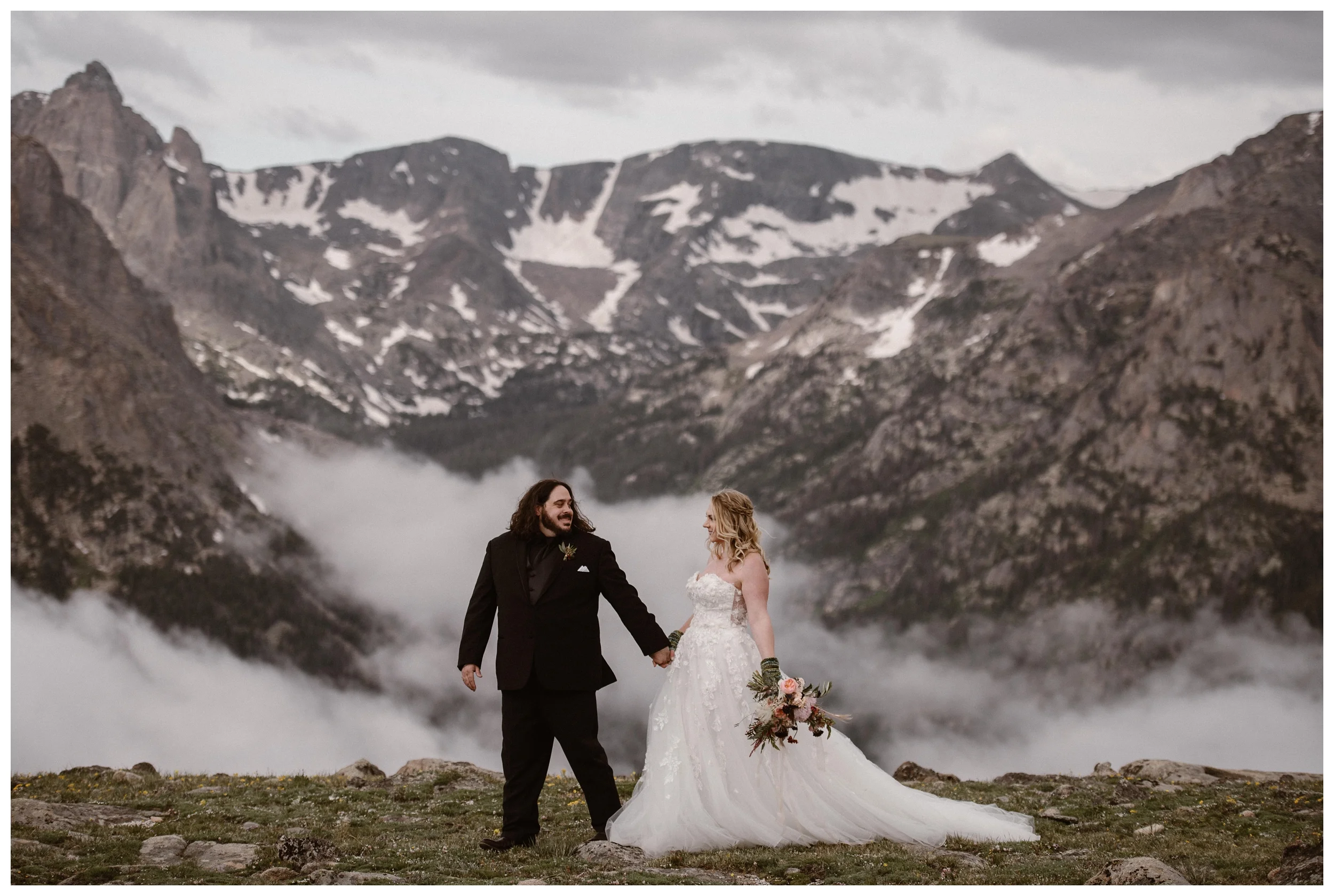 Alicia and Zach walk through the top of Trail Ridge Road for their adventurous couple’s portraits in Rocky Mountain National Park before their intimate elopement. Photo by Adventure Instead, Maddie Mae.