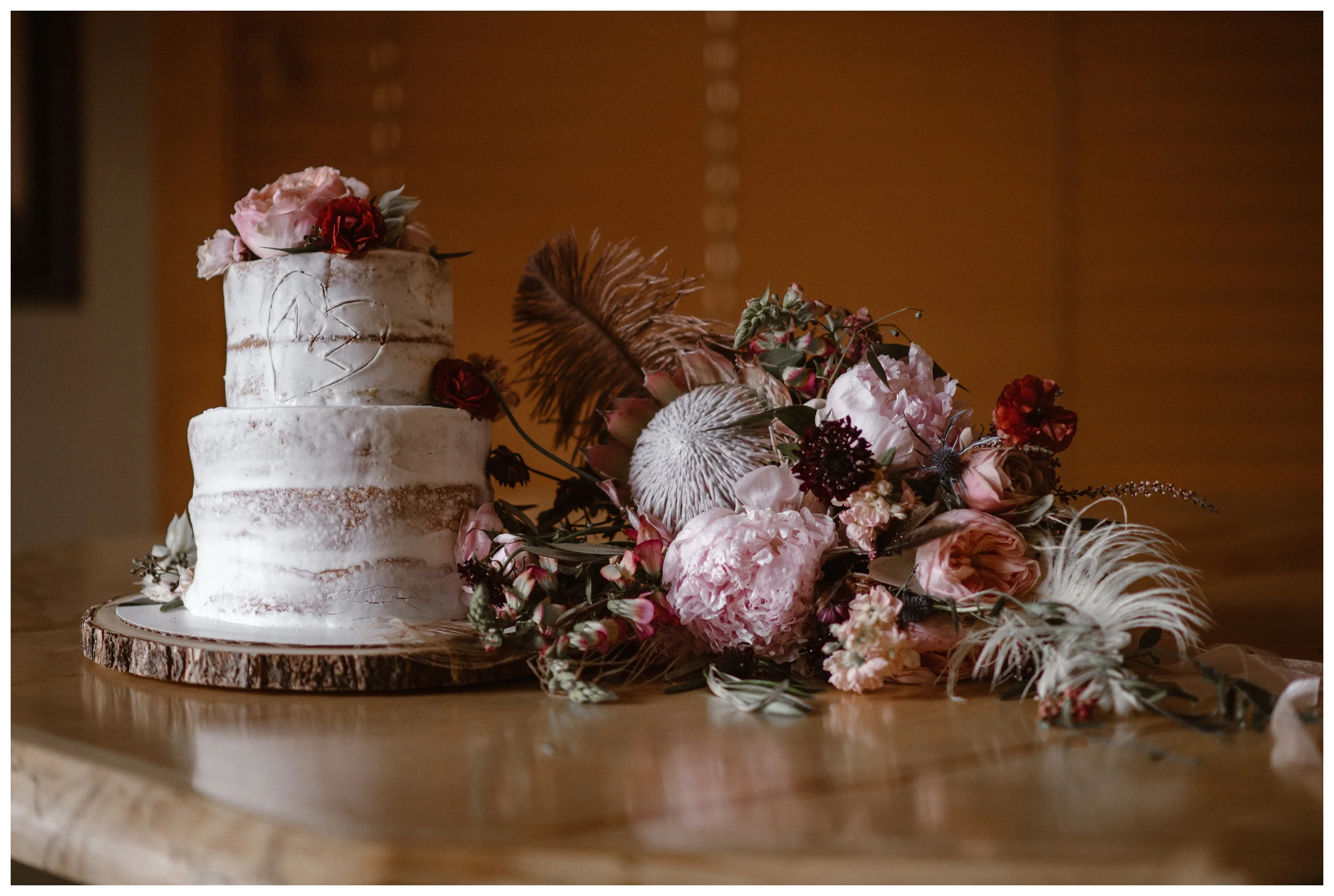 Alicia’s bridal bouquet rests next to the wedding cake that mimics the Rocky Mountains plentiful aspen trees following their elopement ceremony at Rocky Mountain National Park in Estes Park, Colorado. Photo by Adventure Instead, Maddie Mae.