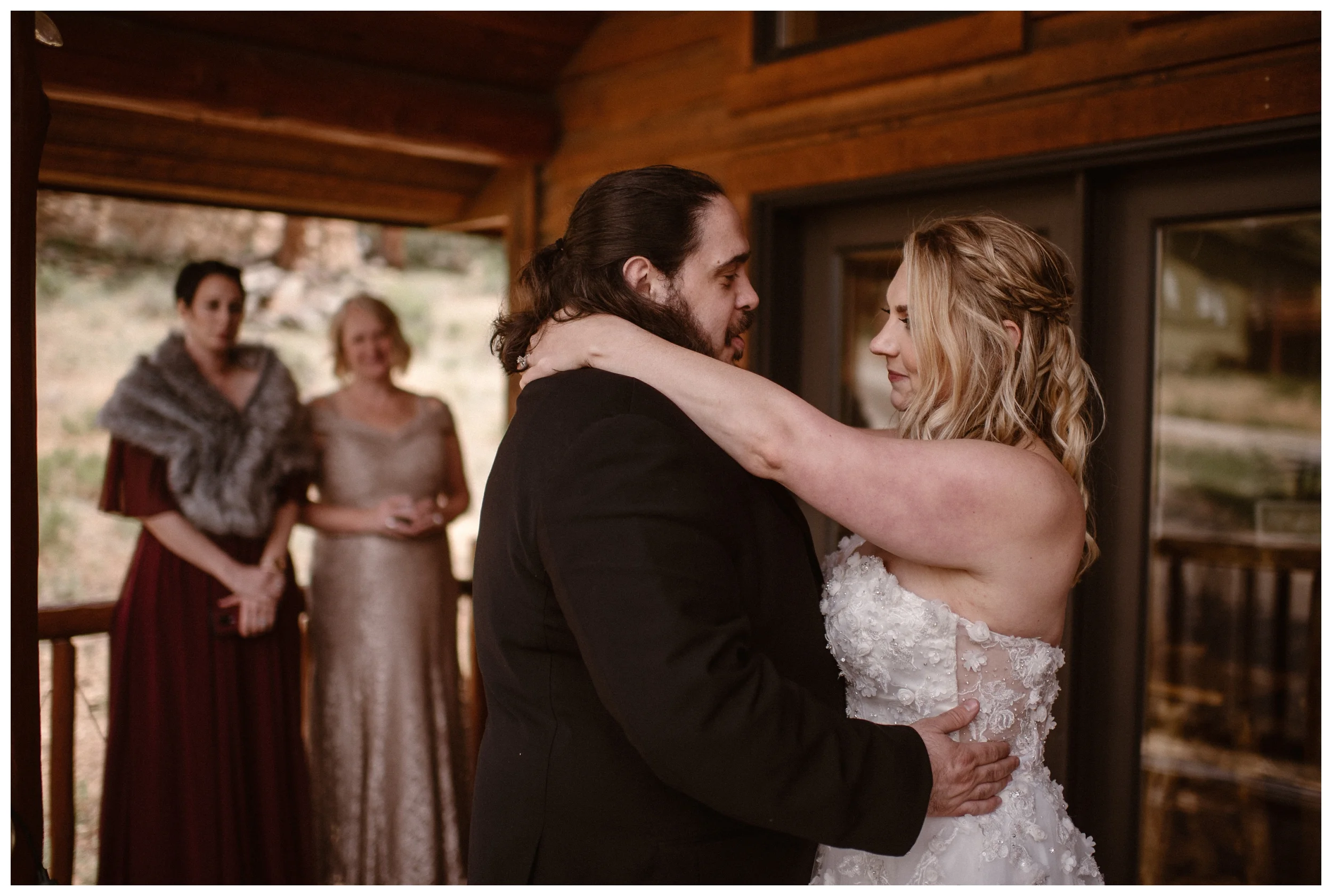 Alicia and Zach share their first dance as a married couple surrounded by family and friends at a cabin in Estes Park after their Rocky Mountain National Park elopement. Photo by Adventure Instead, Maddie Mae.