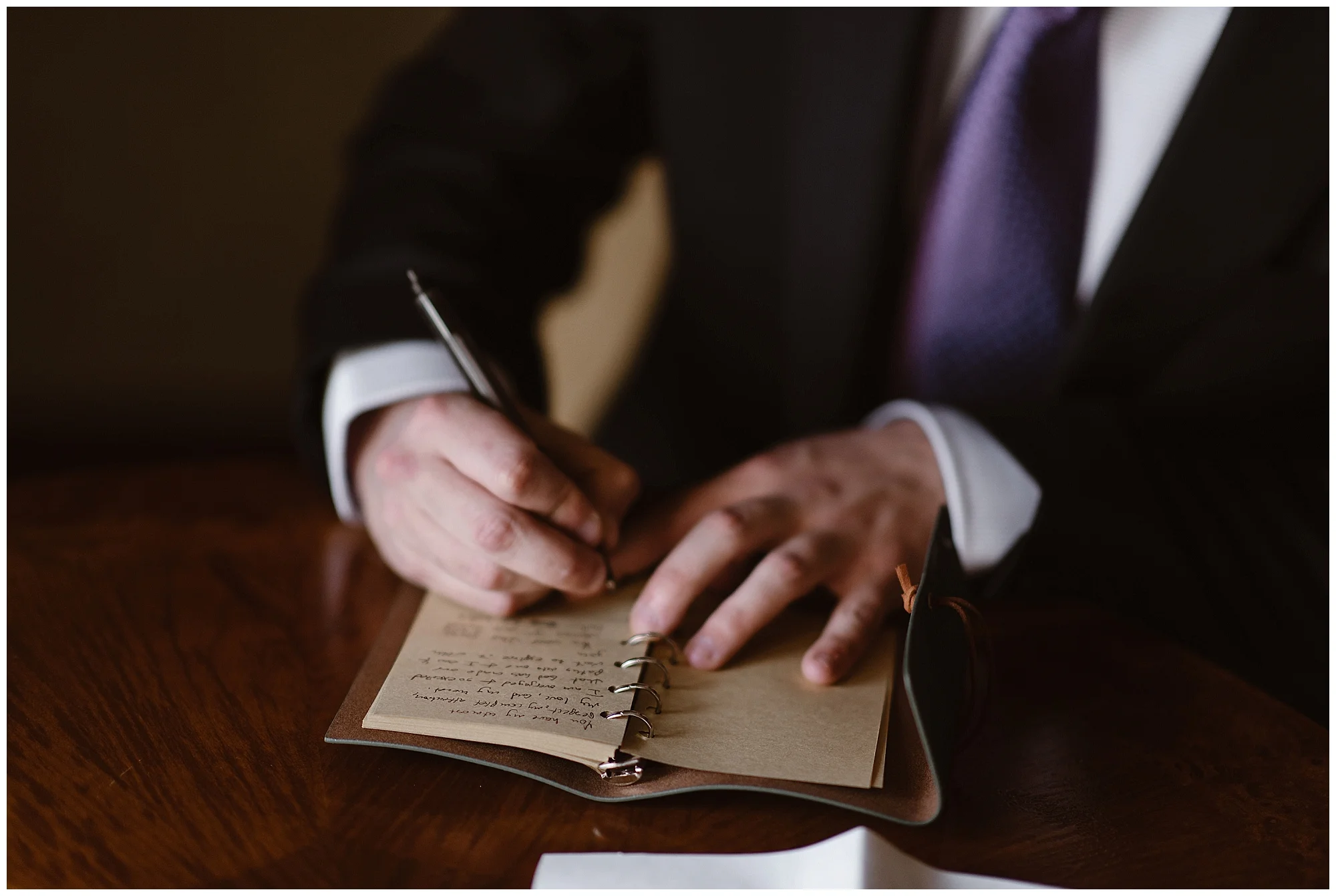 Austin, the groom, writes his vows by hand before his snowy wintery elopement ceremony. Photo by Adventure Instead, Maddie Mae Elopement Photographers.