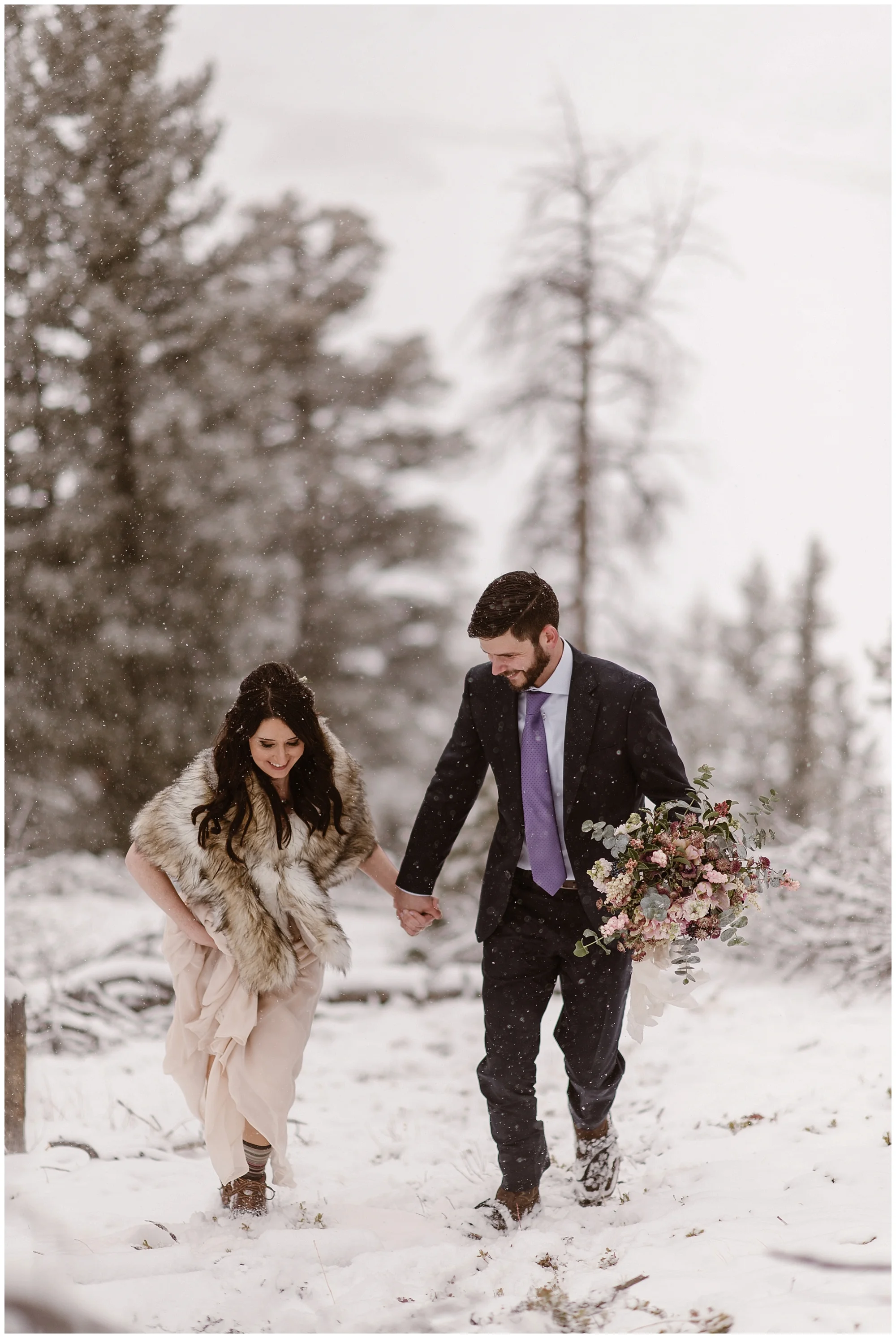 Marlayna and Austin eloped in a scene that looked like a snow globe. Snow fell during their winter elopement at Sapphire Point in Dillon, Colorado. Photo by Adventure Instead, Maddie Mae Elopement Photographers.