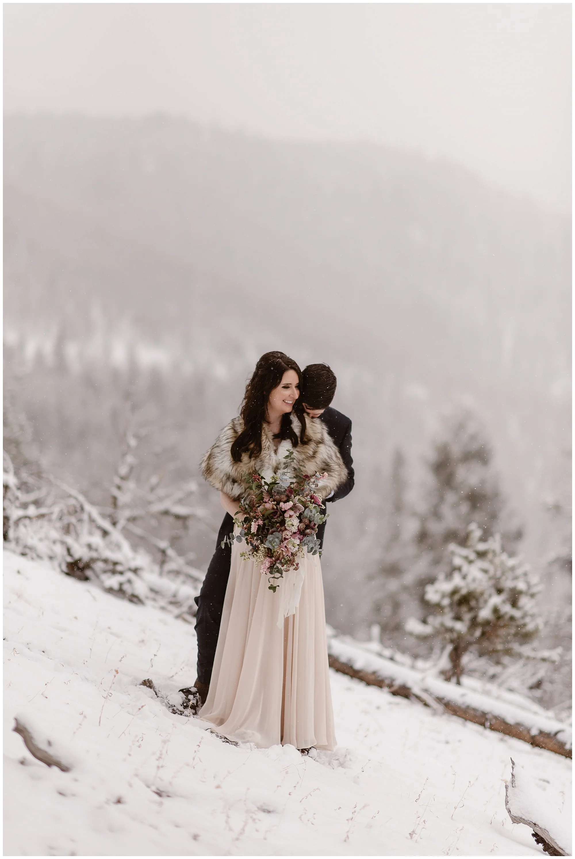 Marlayna and Austin embrace before their snowy winter elopement ceremony. They chose to self solemnize their wedding and travel to Colorado to get married. Photo by Adventure Instead, Maddie Mae Elopement Photographers.