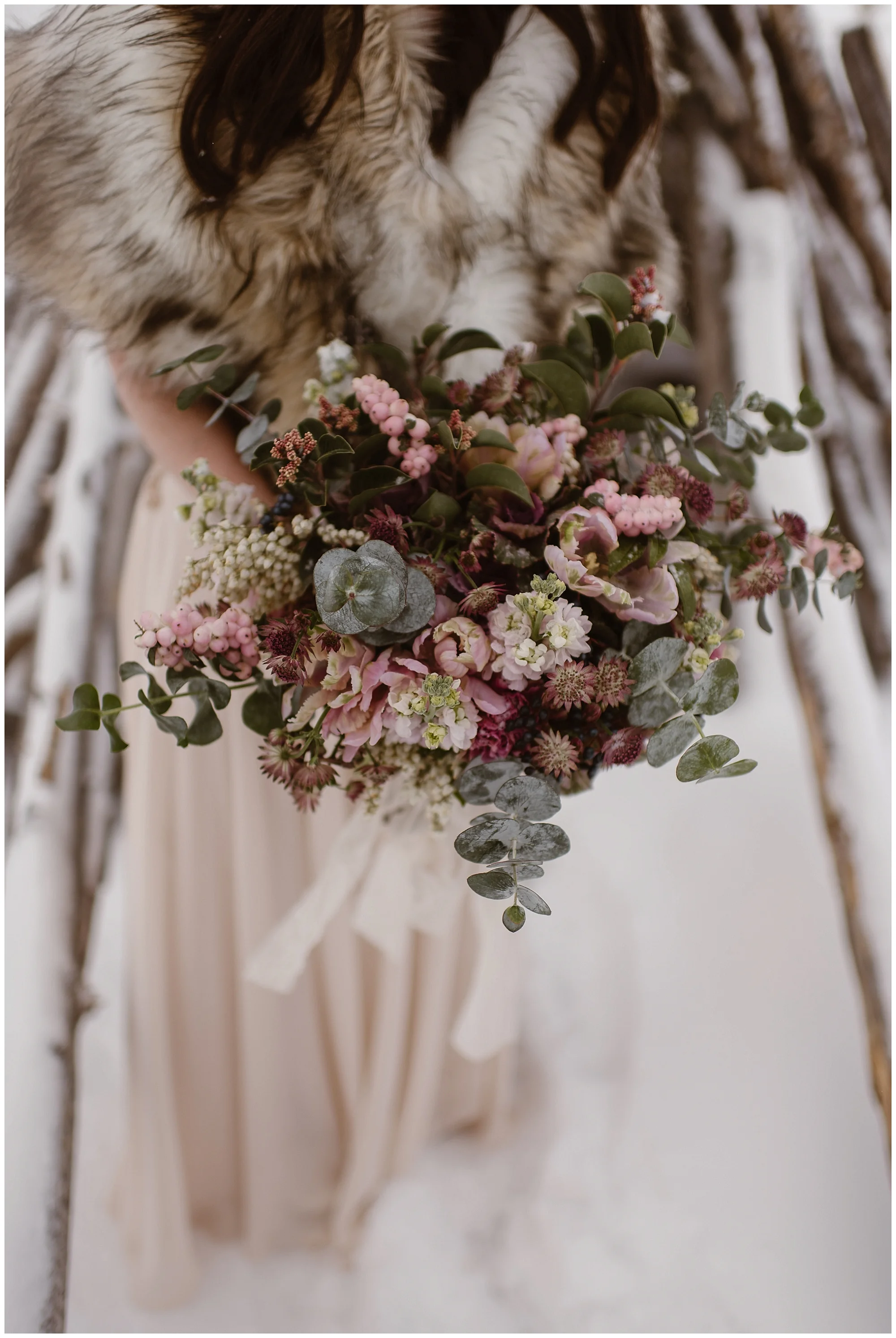 Marlayna’s big beautiful bridal bouquet was so beautiful against the snowy backdrop of Sapphire Point in Dillon, Colorado. Photo by Adventure Instead, Maddie Mae Elopement Photographers.