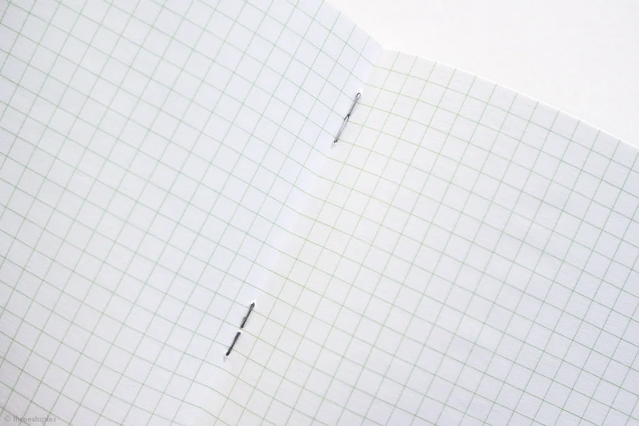 Silver staples + green graph grid.