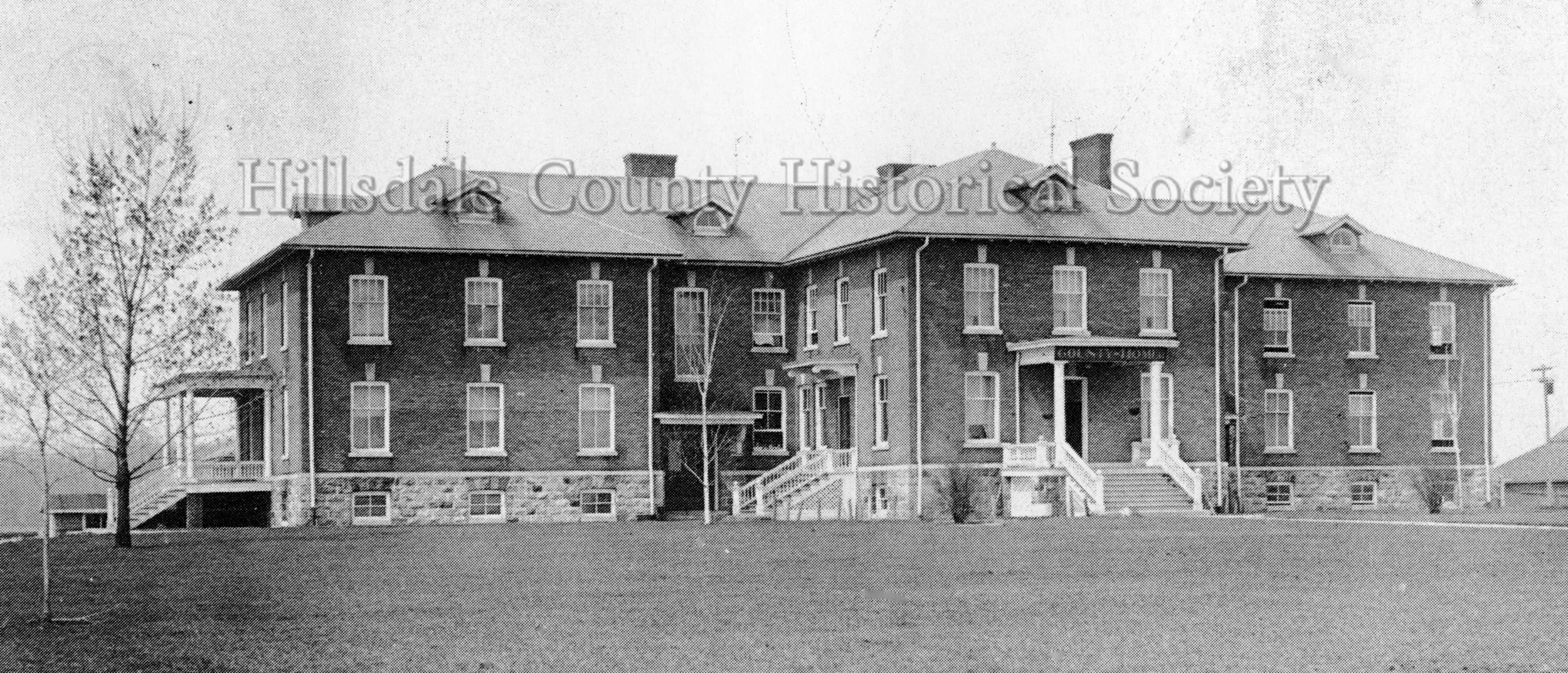 If you look closely you can see a sign that says "County Home" on the front of the porch roof.