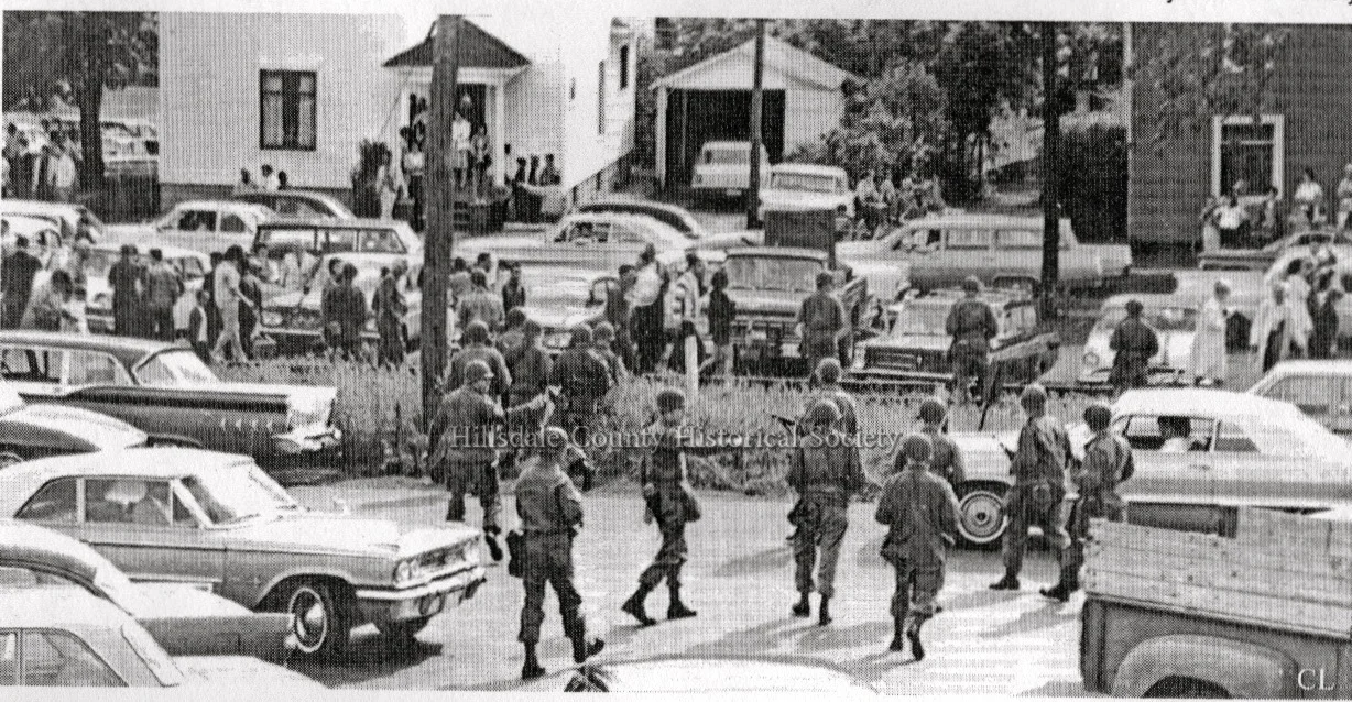 National Guardsmen moving west from Savarino's parking lot disperse workers.