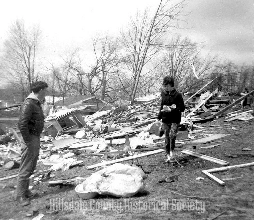 an unidentified couple sift through what little remains of their belongings at bear lake.