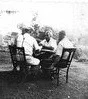 Men from Little Italy play cards in the back yard