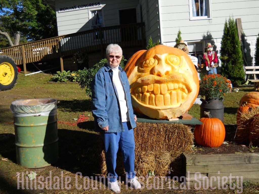 a smiley face carved into a huge pumpkin is one of the novelties you can see at the fair