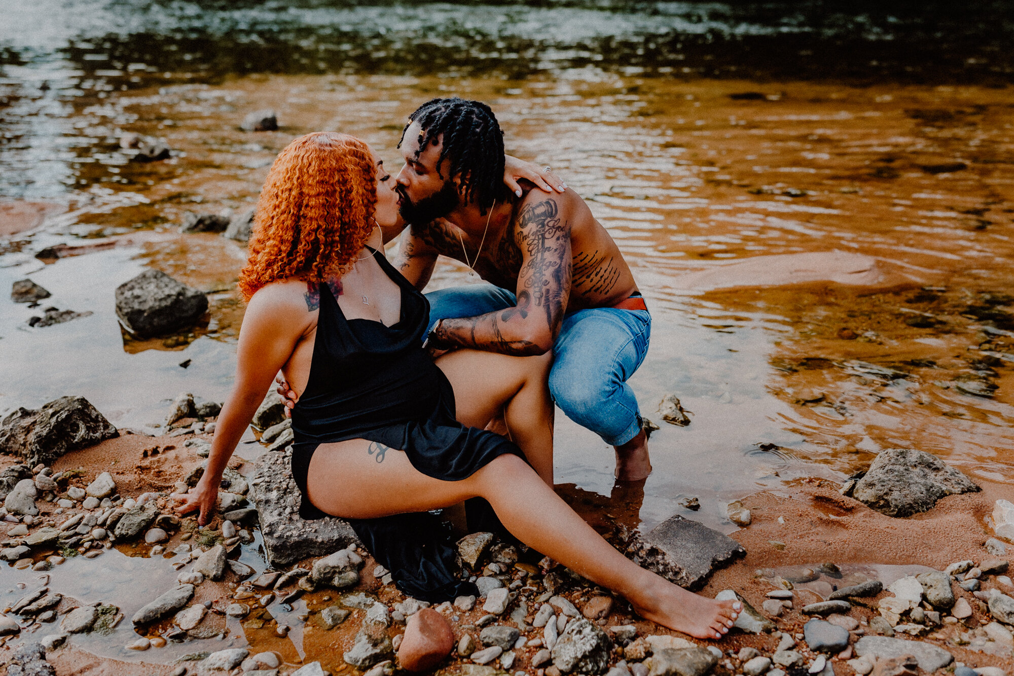 man kneels down by his wife for a kiss