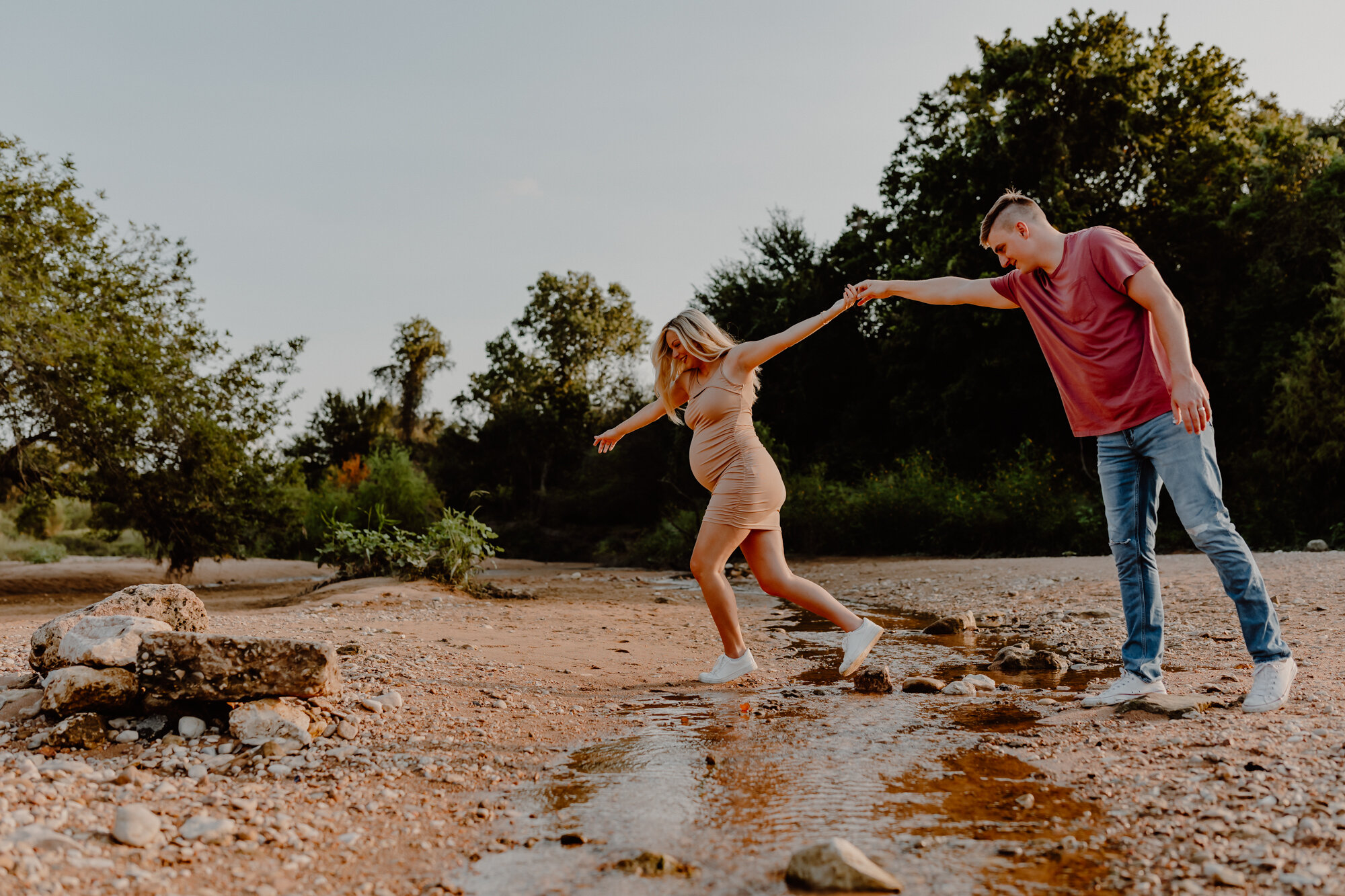 woman and man crossing over the river