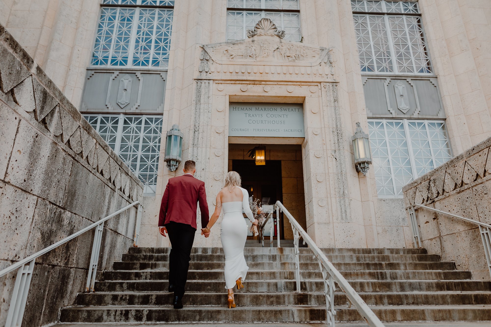 bride and groom on steps at Austin courthouse