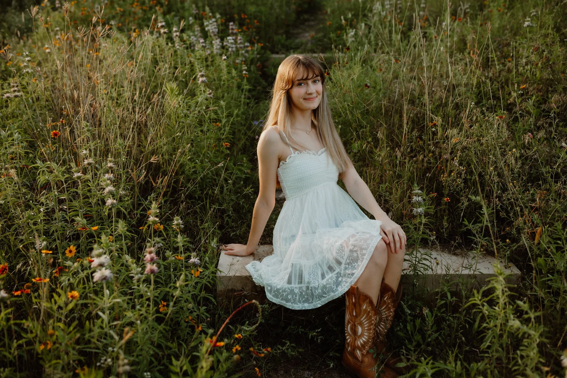 Spring senior portrait in Austin, Texas — Dylann among wildflowers, photographed from baby to senior by the same family photographer.