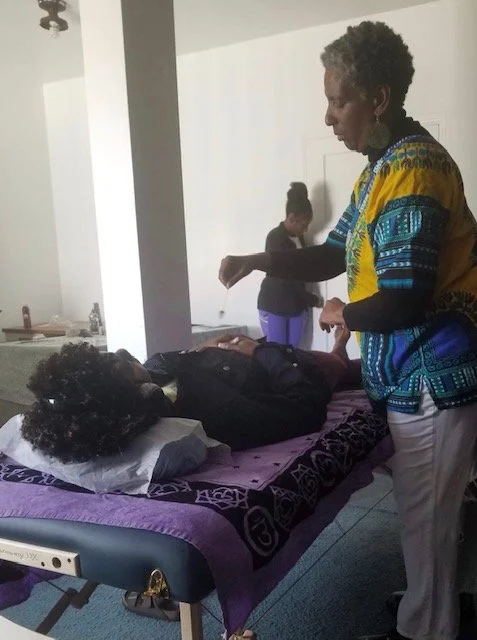 Rhonda Kuykendall-Jabari offering Reiki at a community event