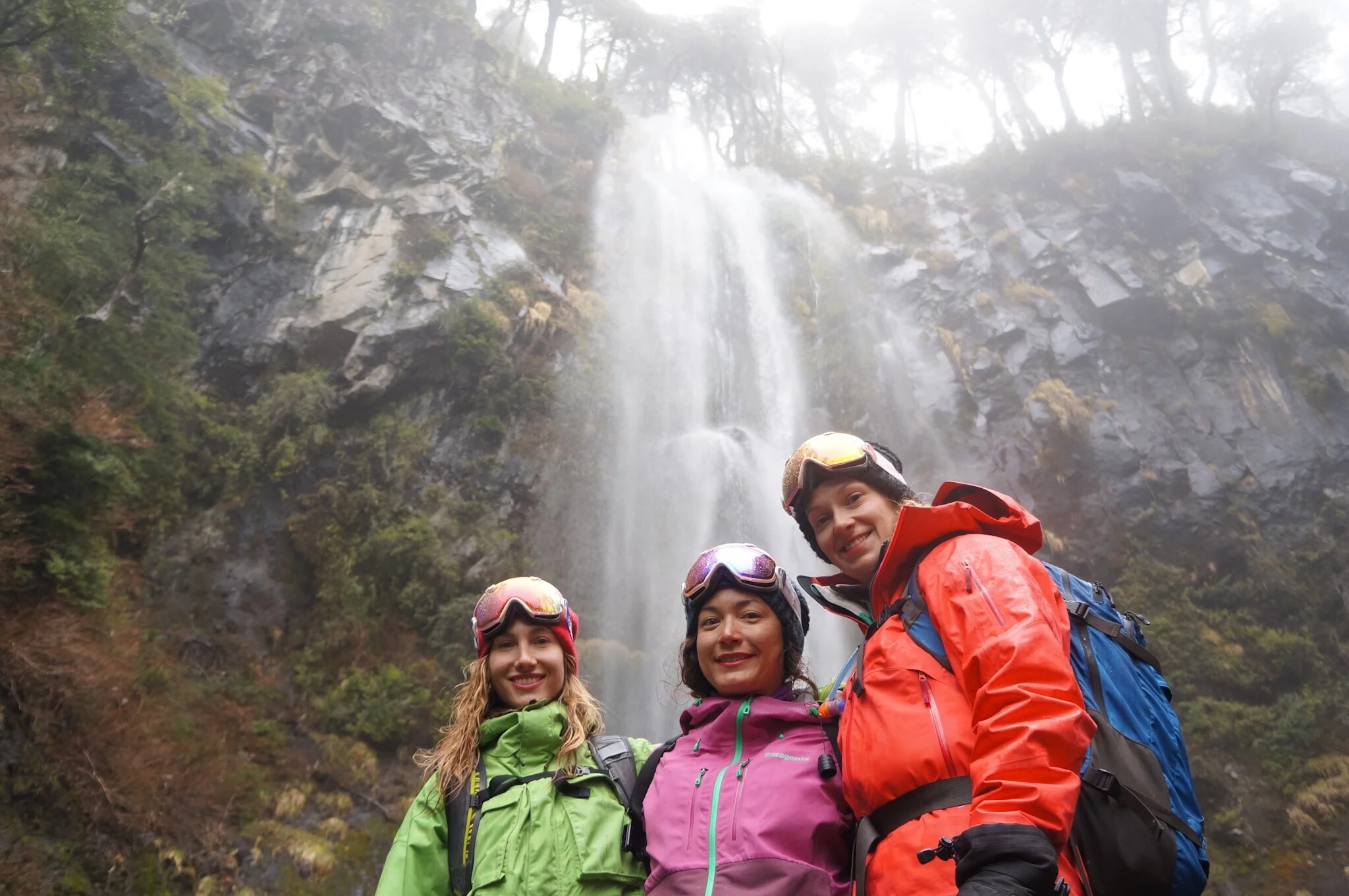 Checking out a waterfall on a wet day in the Andes.