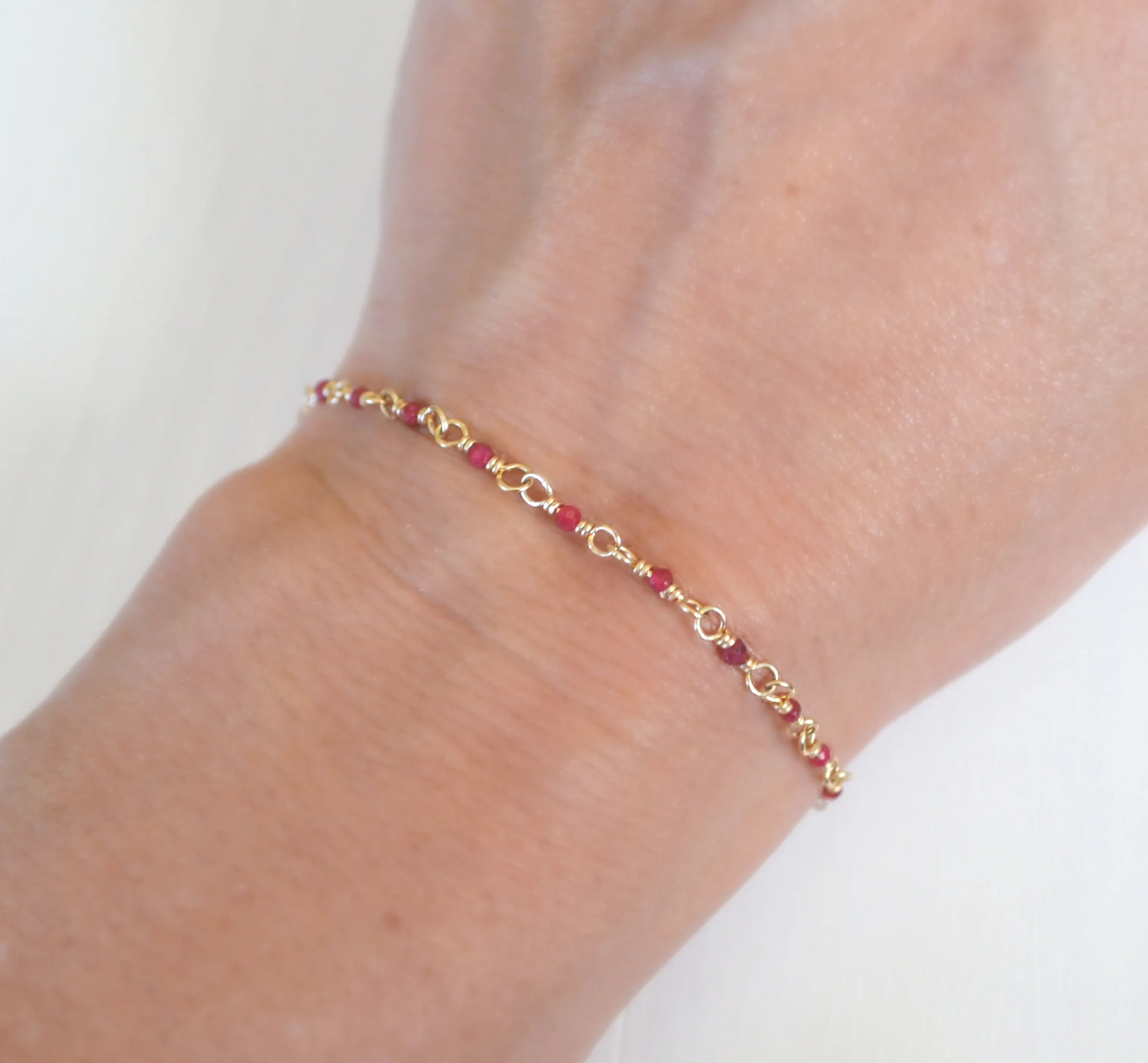 tiny gold filled ruby beaded bracelet.JPG