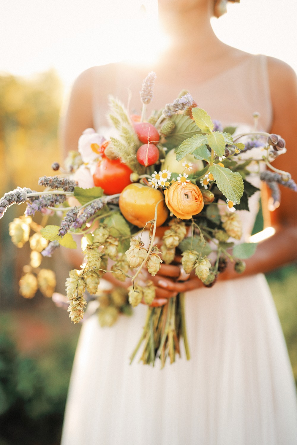 organic bridal bouquet with lavender, hops, ranunculus, radishes and heirloom tomatoes