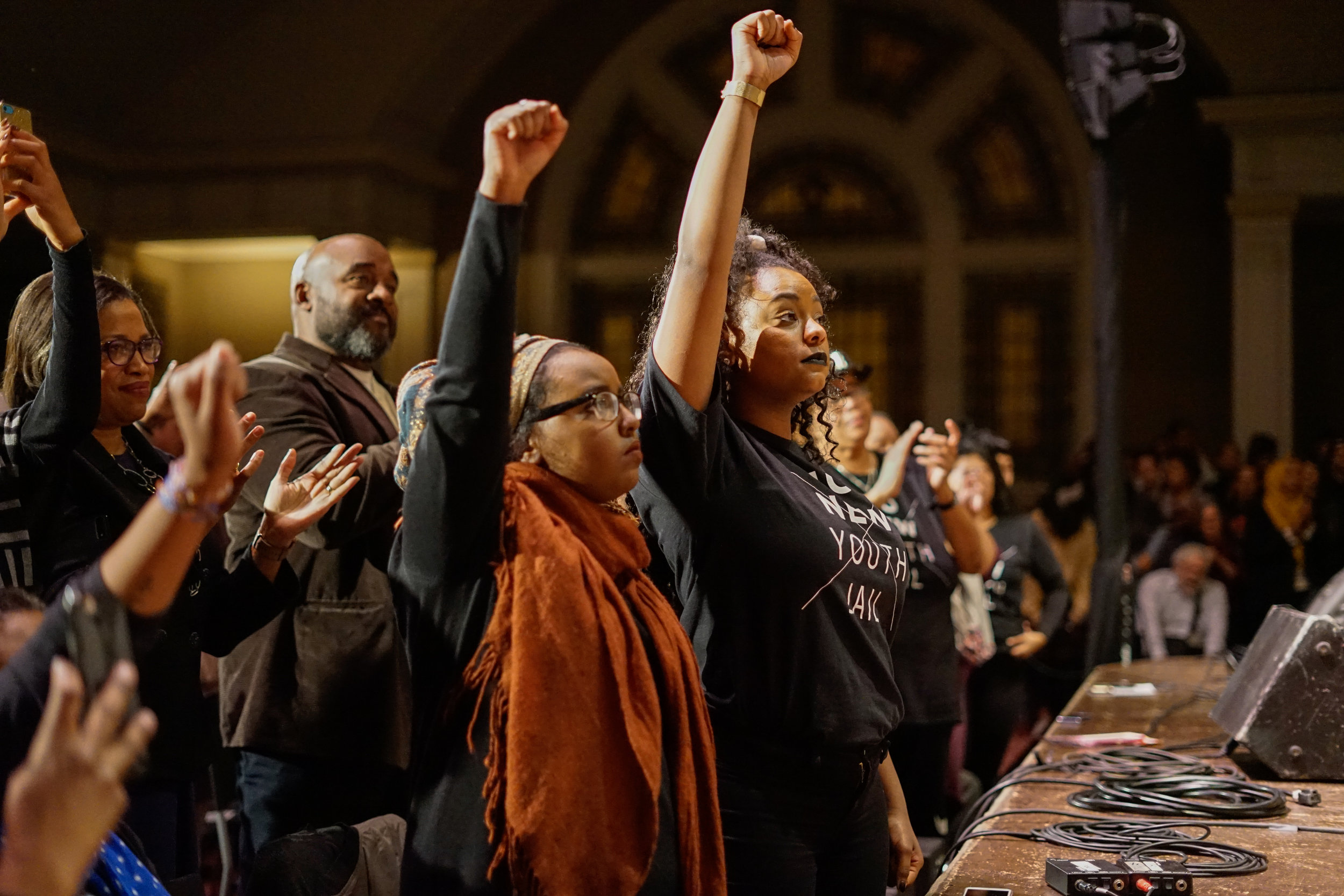  No Youth Jail activists raise their fist in support of Angela Davis’ opposition to mass incarceration at Seattle’s Town Hall. Jan 17, 2017. 