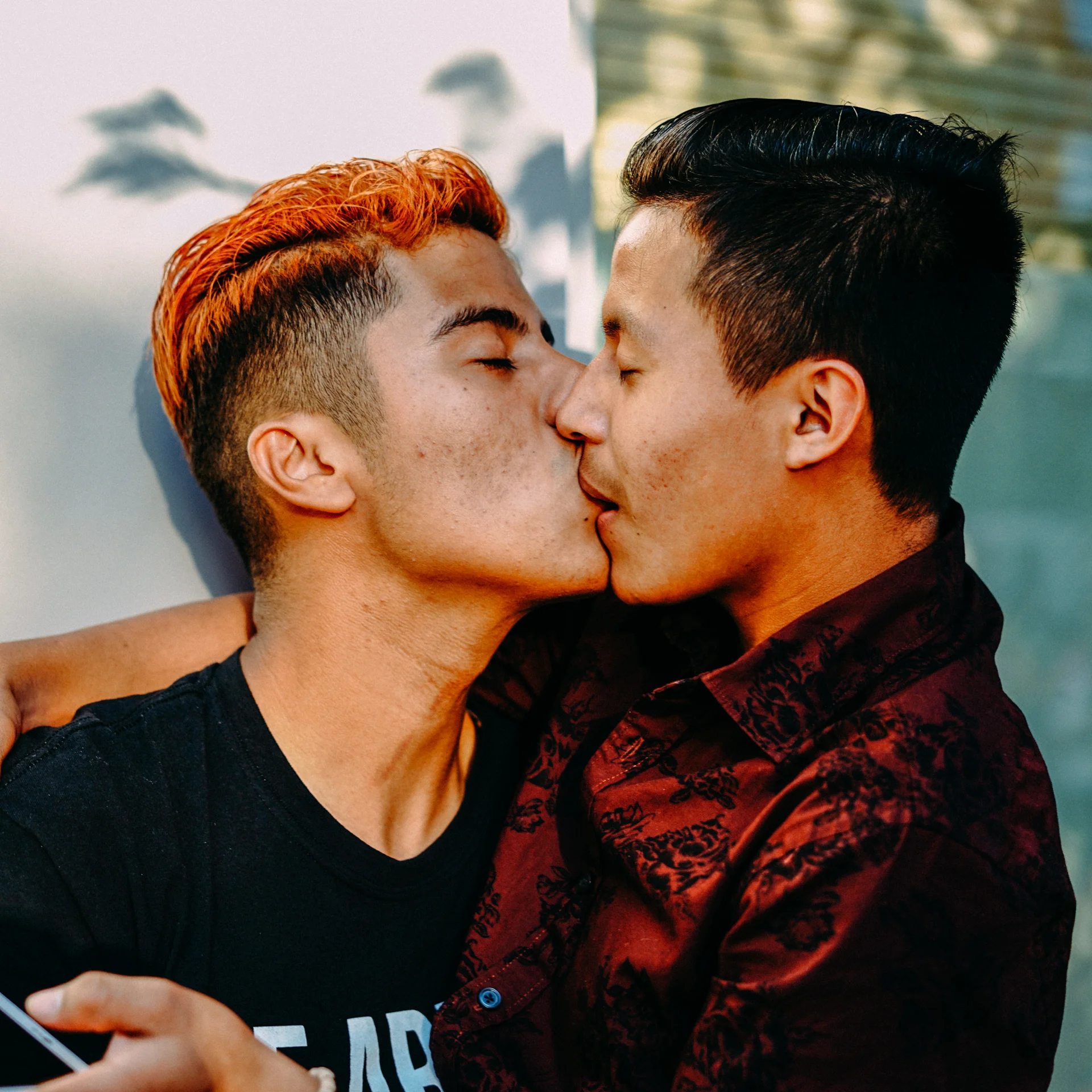 A couple shares a kiss as Seattle officially declares July 14th Latinx Pride Day.