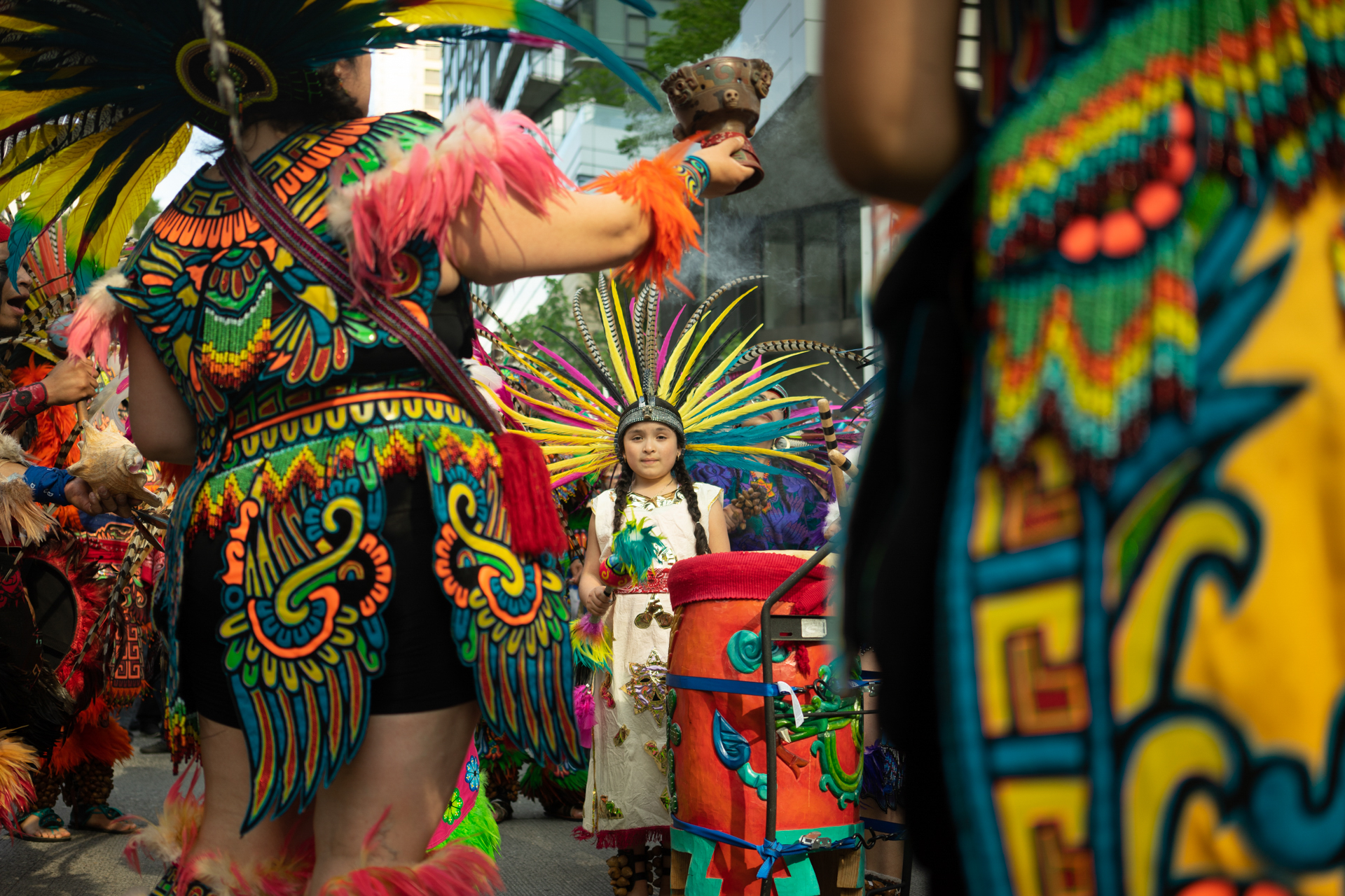  A young member of CeAtl Tonalli, an Aztec dance group,  leads the annual Labor Day march on May 1, 2018 in Seattle, Wash.  