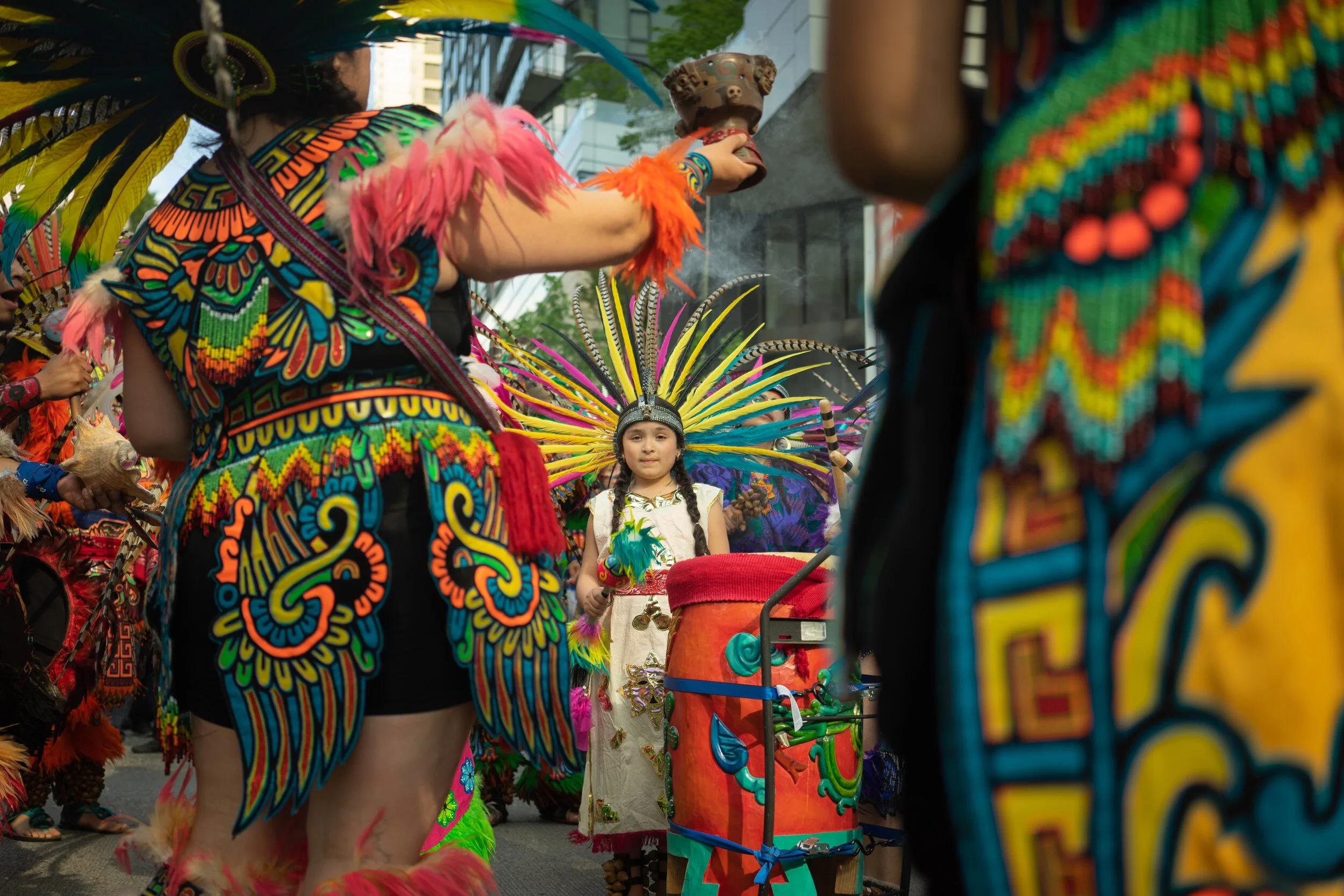 The youngest member of CeAtl Tonalli , an Aztec dance troupe, leads the annual May Day rally for worker’s rights.