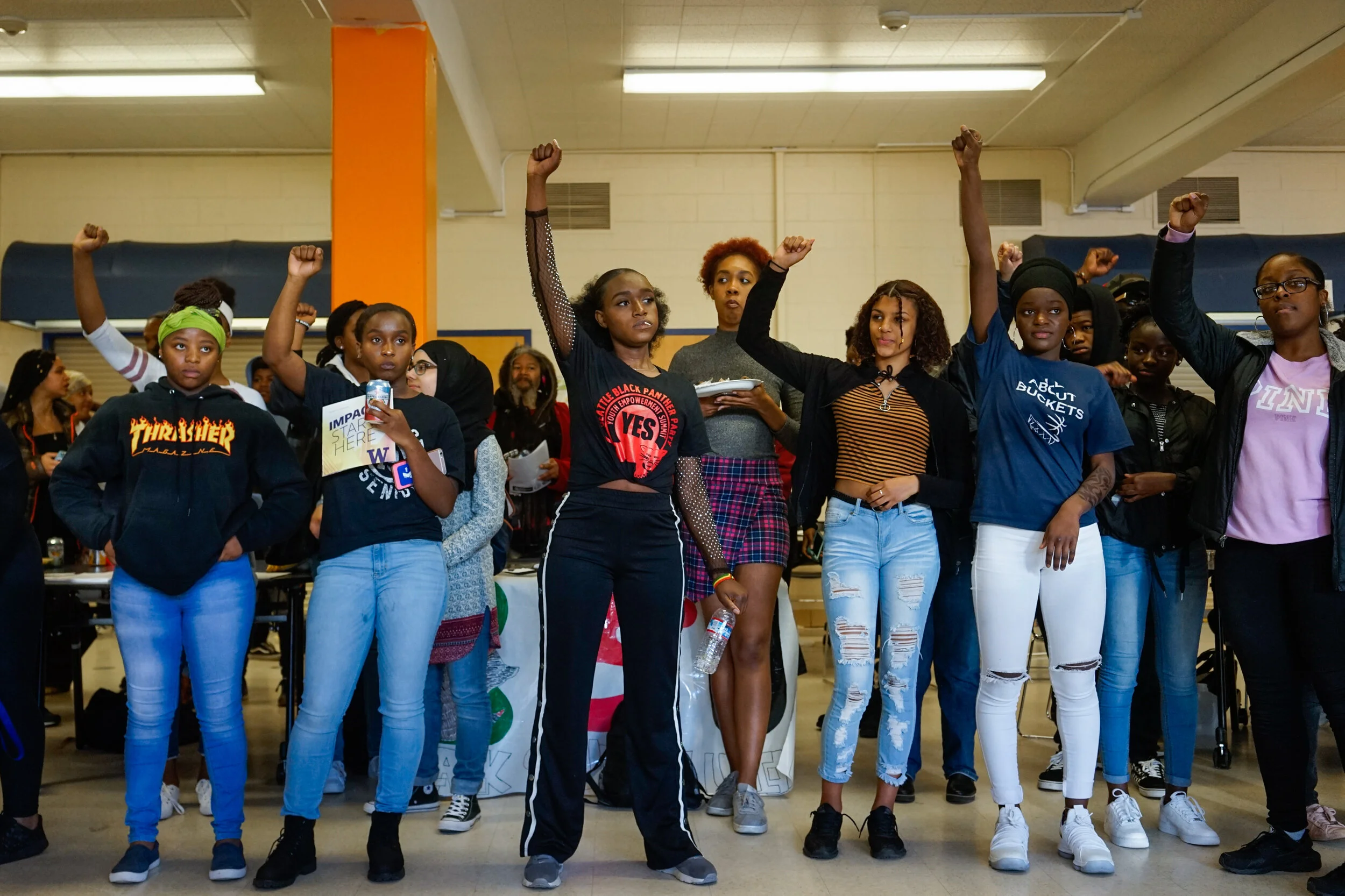 Students at Rainer Beach High school rise their fists at the Youth Empowerment Summit run by the Seattle Black Panther Party on November 10, 2018