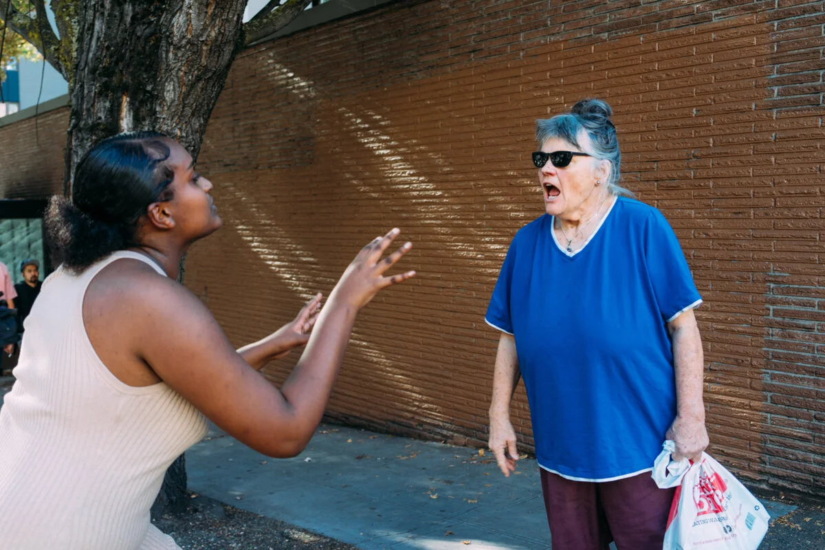 A student from Seattle Public Schools confronts a heckler on the street during a protest supporting DACA recipients and their families.